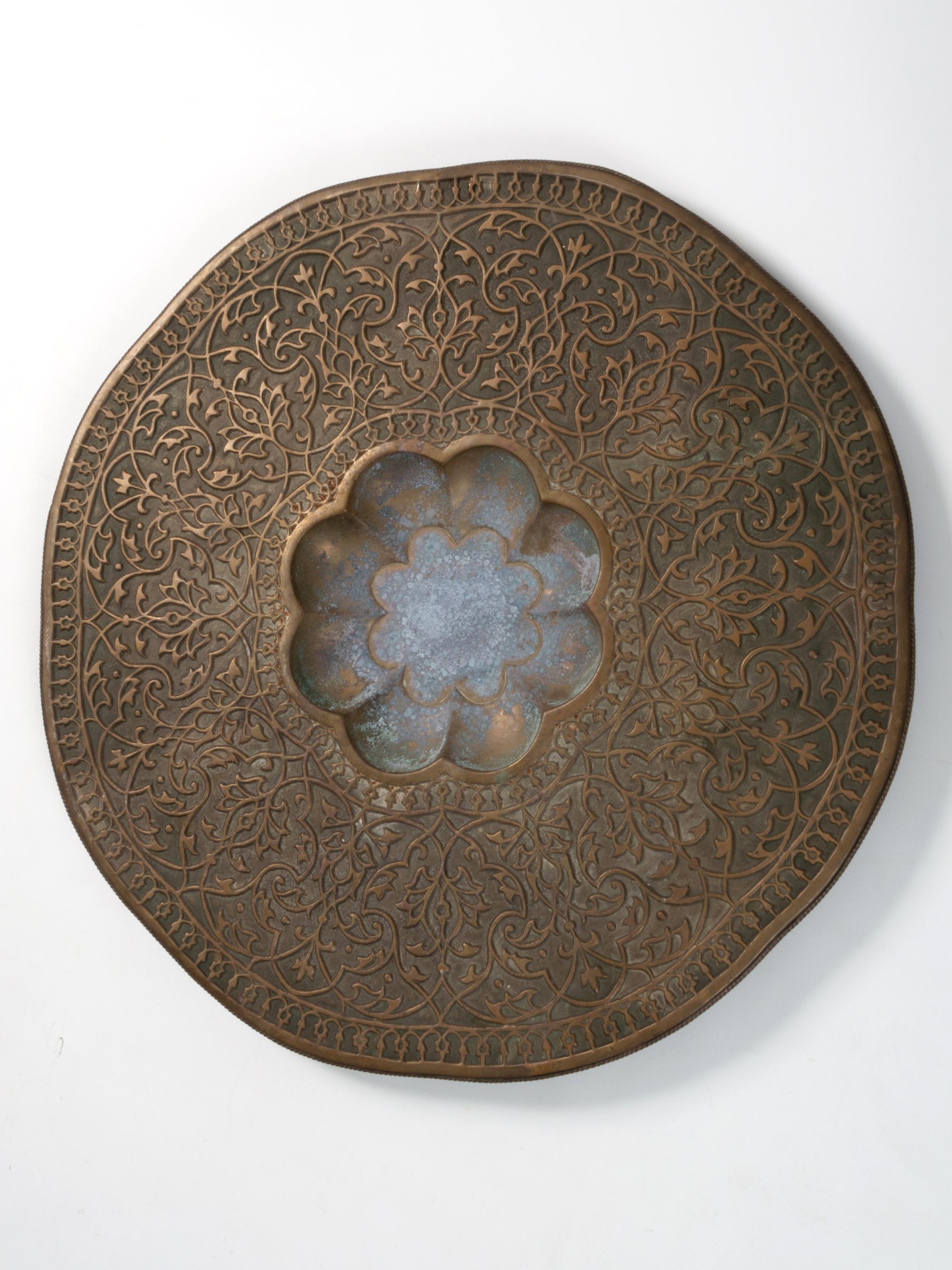A Large 19th Century Turkish Brass Copper Wall Charger C.1850.
Beautifully hand engraved stylised floral motifs with attractive patination to the coppered brass.

Could be used as an ornate serving platter

In good condition with expected signs of