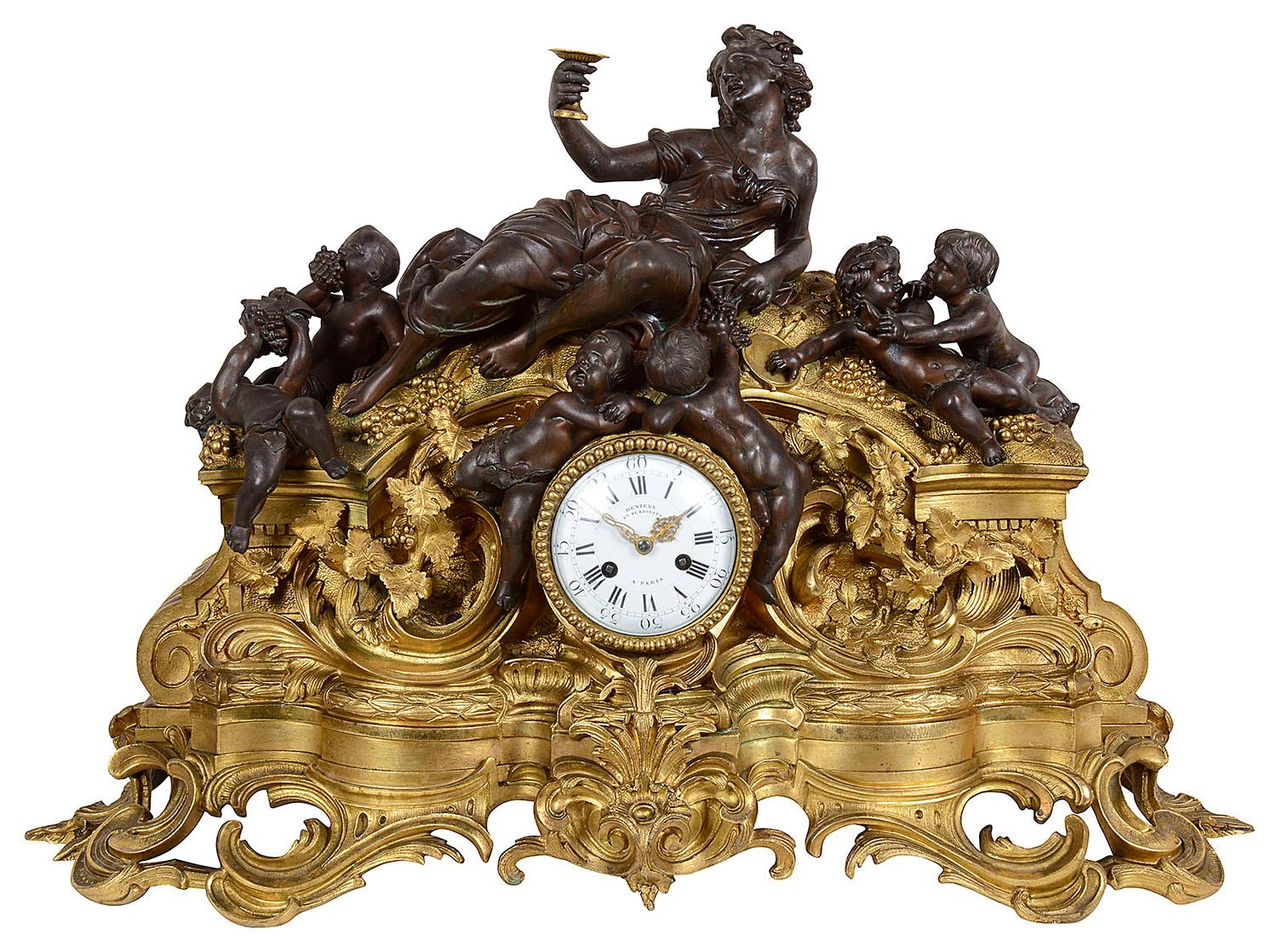 A very impressive 19th century Louis XVI style Bachuss influenced bronze and gilded ormolu clock garniture. The pair of four branch candelabra each supported by bronze putti, raised on gilded ormolu tripod bases with shell and rams head mount.
The