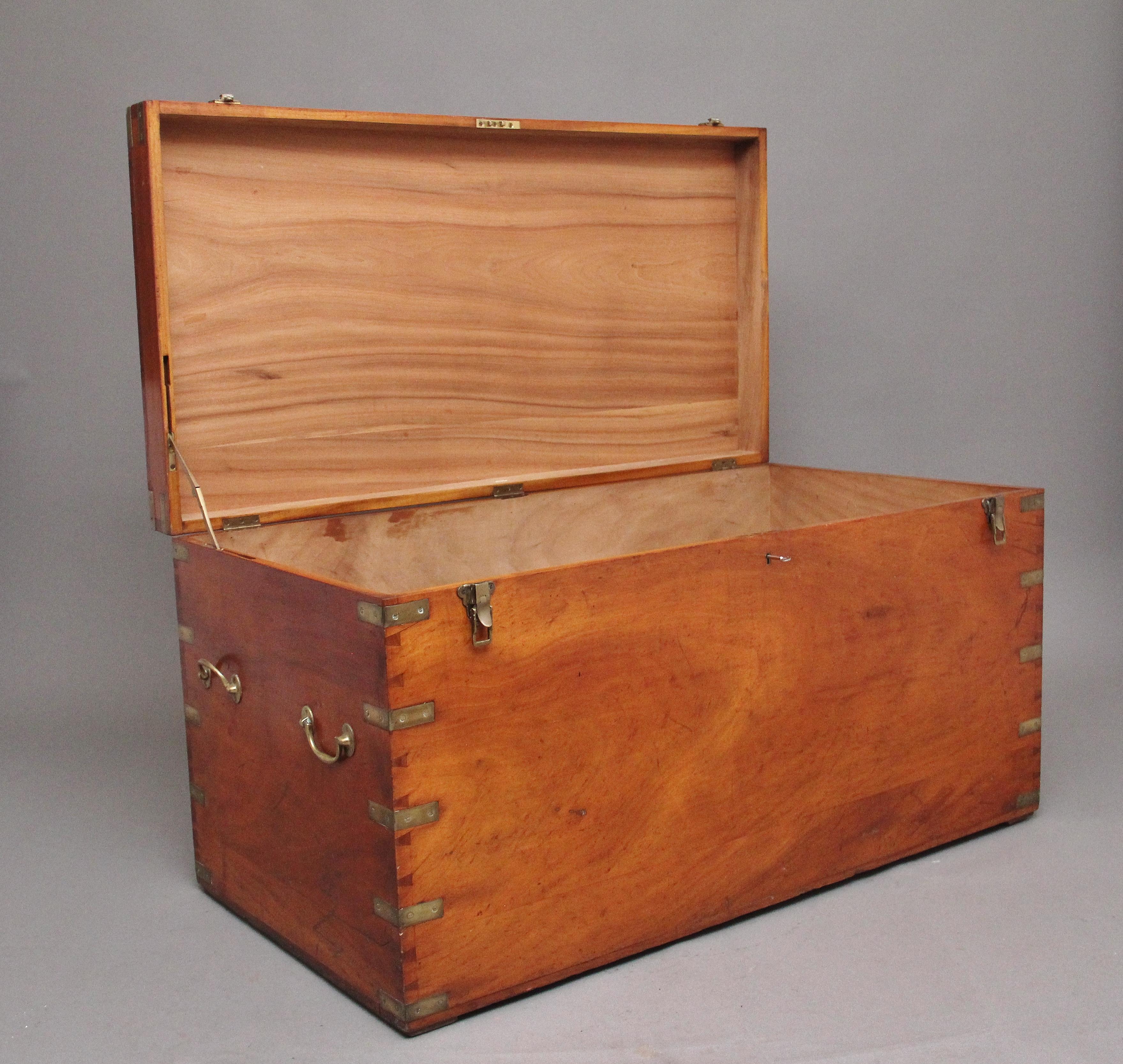 A large 19th century camphor wood military trunk / chest in fantastic condition, having brass corner straps, recessed handles and lock latches, two original brass carrying handles and each side of the trunk, the hinged lid opening to reveal a large