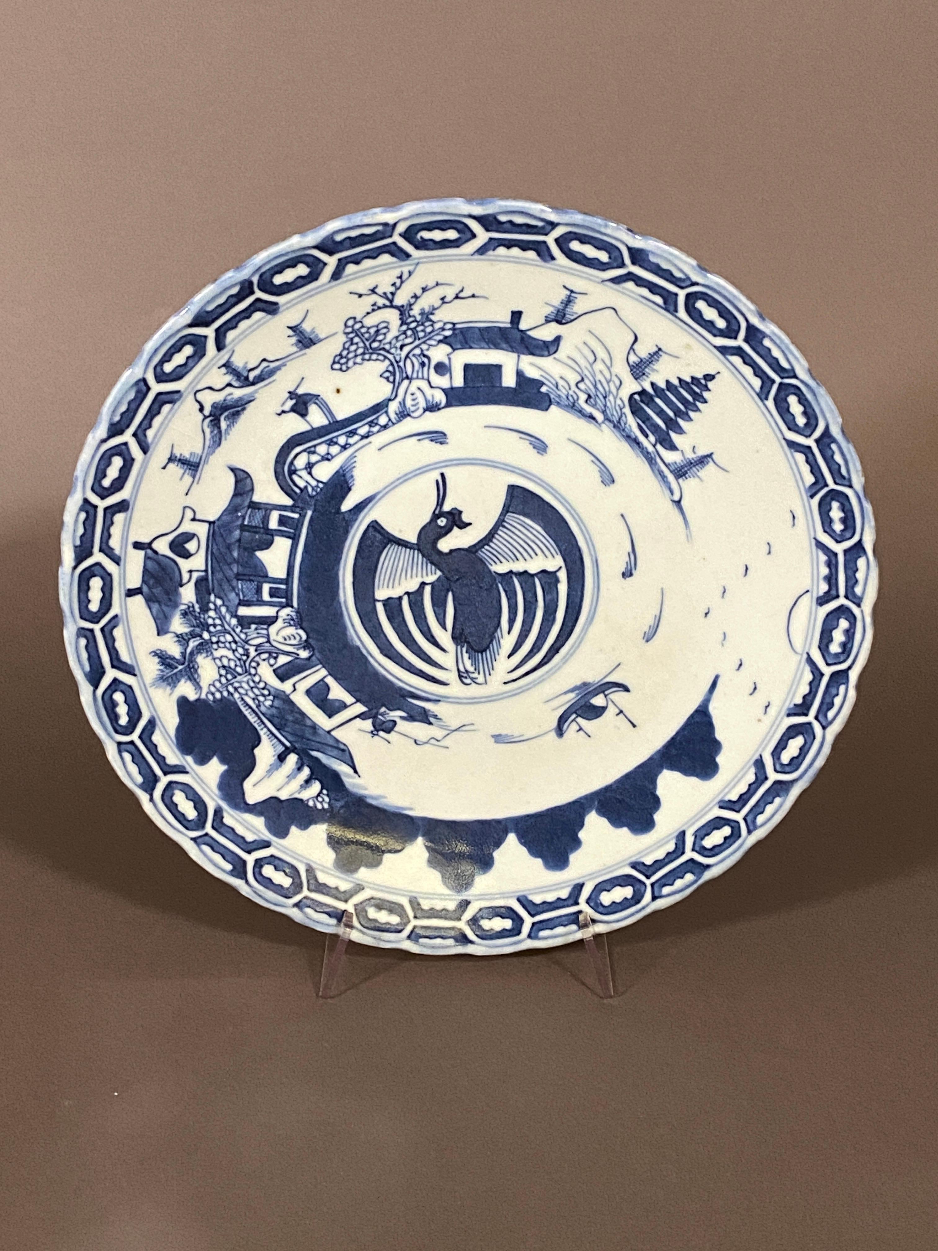 Large 19th century China blue and white porcelain plate with a phenix, pagodas and landscape with a mark and a wax stamp on the reverse.
