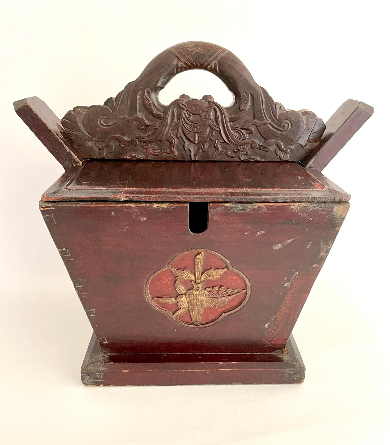 Beautifully carved Qing dynasty tea caddy from Elmwood (yumu), with floral motifs and finished with an oxblood color lacquer. The handle has a finely carved bat motif, which symbolizes good fortune. The large size is very usual and was used in a