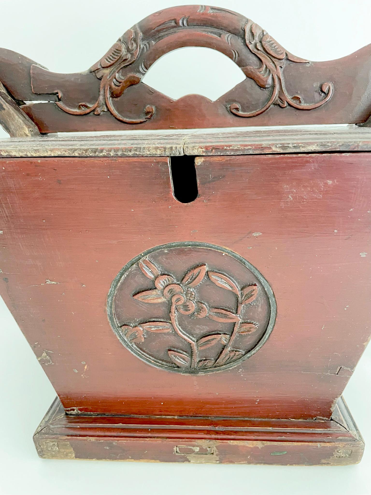 Beautifully carved Qing dynasty tea caddy from Elmwood (yumu), with floral motifs and finished with an oxblood color lacquer. The large size is very usual and was used in a large family compound. The tea caddy is designed to hold and keep warm,