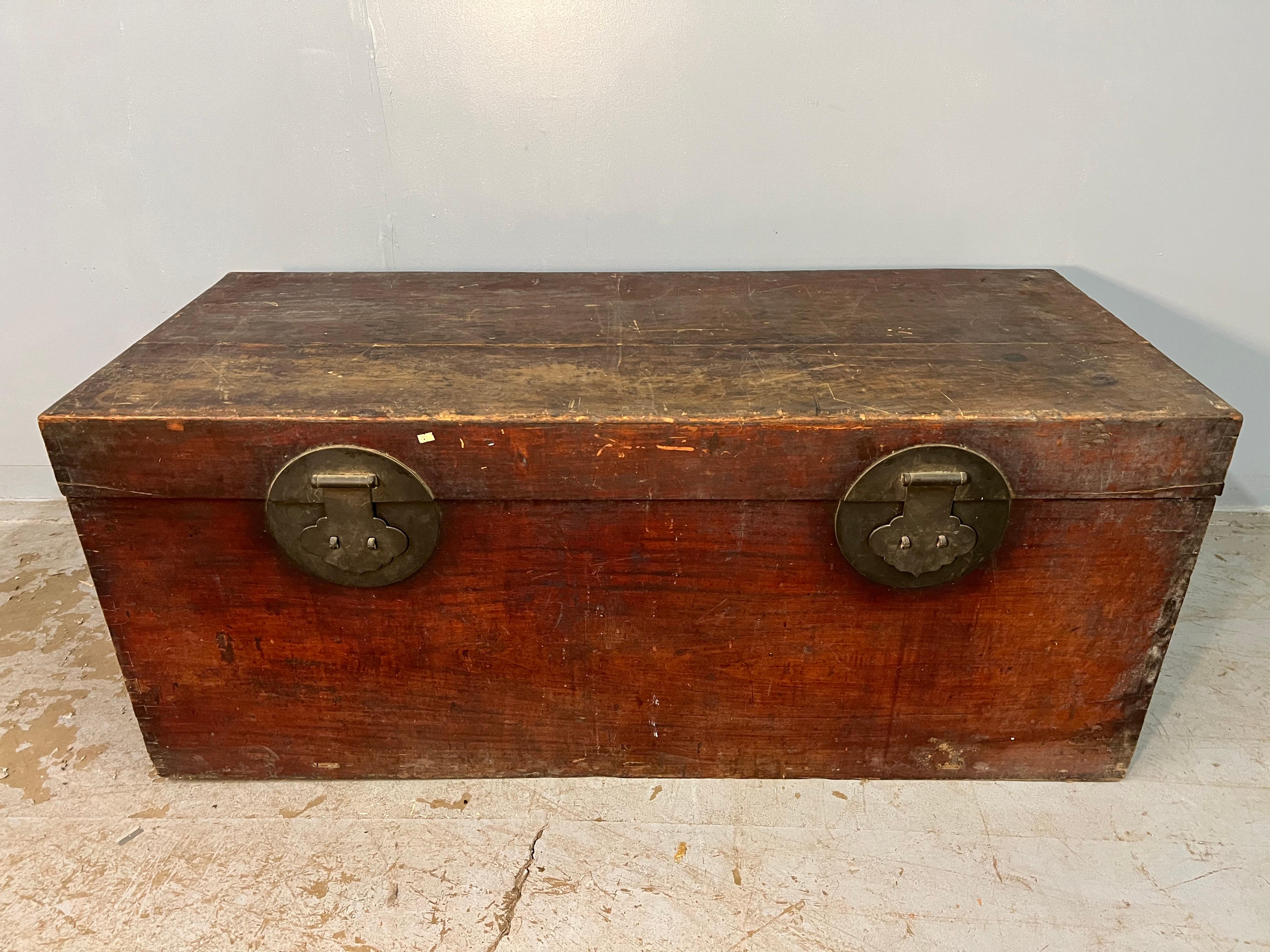 This very large camphor wood trunk is incredible with a wonderful old patina and large oxidized hardware. It is a wonderful storage piece and is tall enough to be used as a hall table.
 