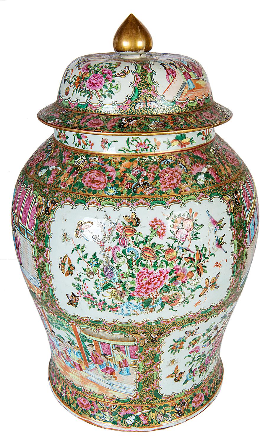 A large and impressive 19th century Chinese Cantonese / rose medallion lidded vase, having a gilded finial to the lid, green and pink floral and foliate boarders to the inset panels depicting classically dress Chinese people socializing in the
