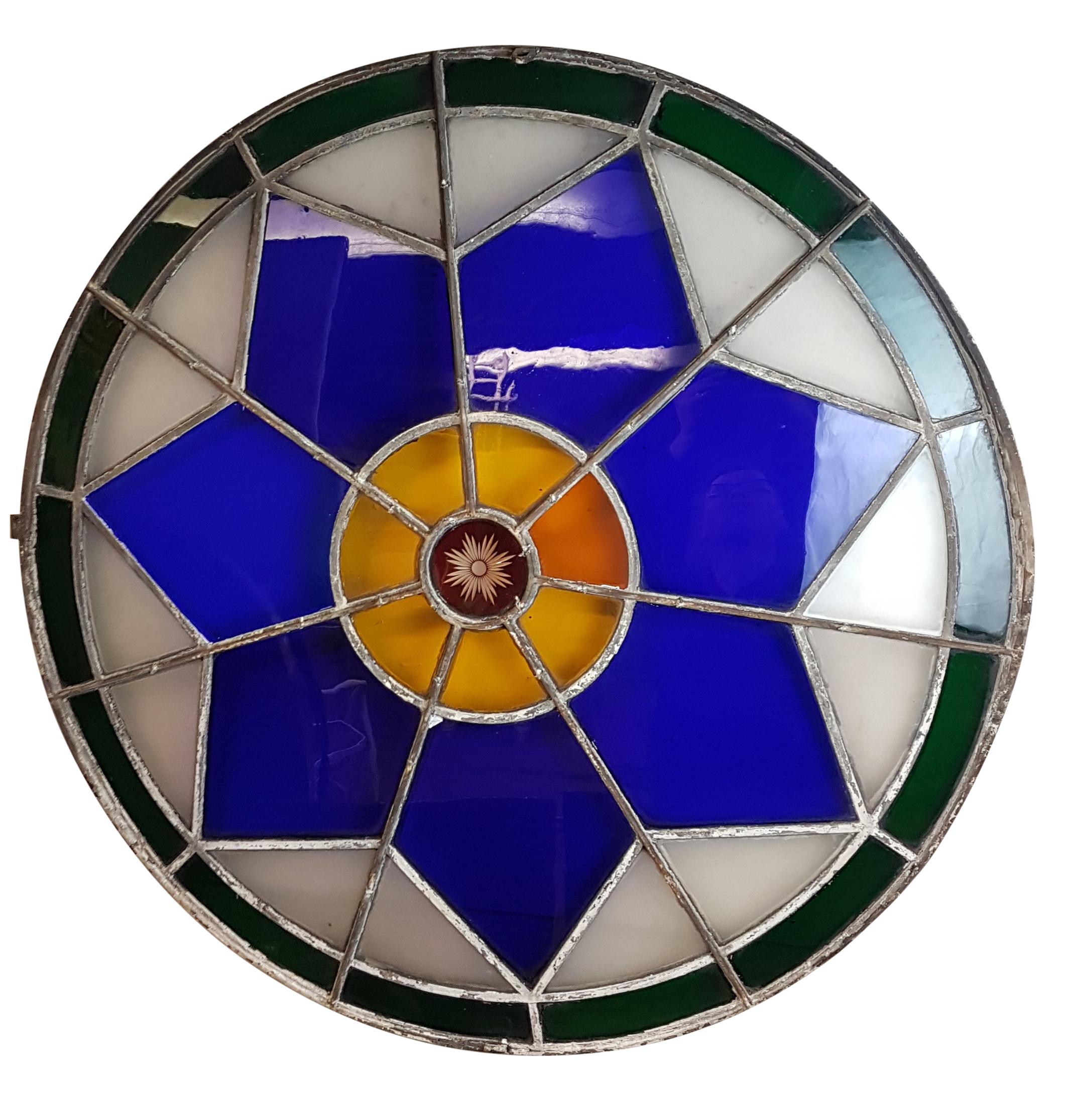 A truly stunning large original 19th century leaded stained glass circular window with cast iron frame. Majority of the glass is original with great rippling, has an etched ruby glass centre surrounded by amber glass (one of which is replaced), this