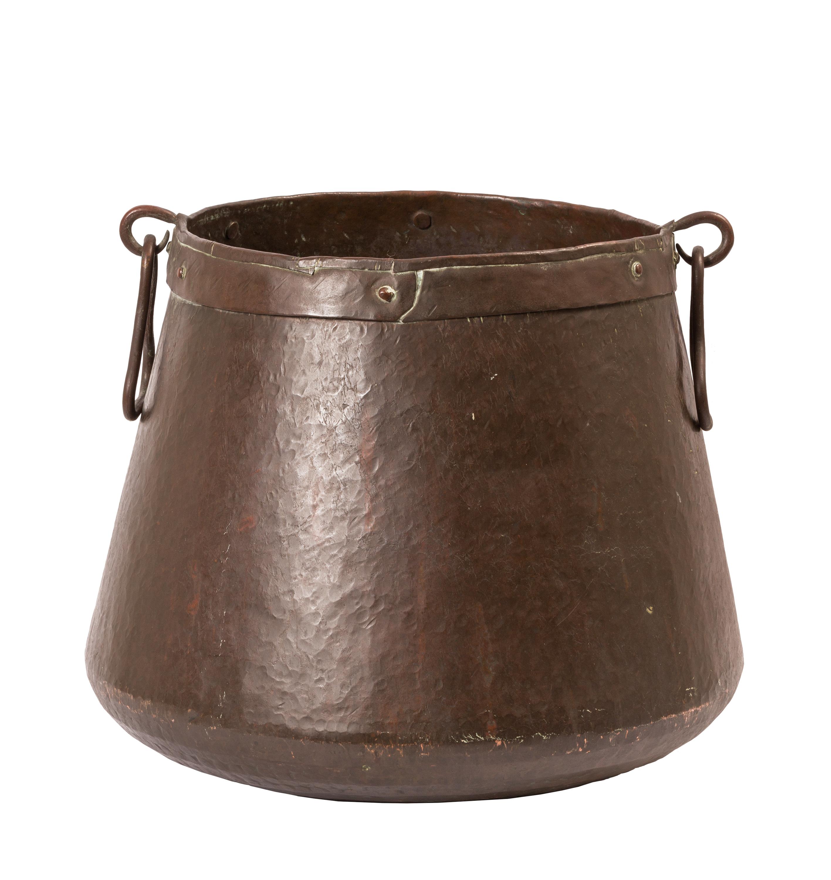 This large size 19th century hand-hammered copper cauldron cook pot with rich chocolate brown patina is paired with a heavy wrought iron tripod. Originally designed to sit directly above the hot coals of a cook fire or fireplace, rich country stews,