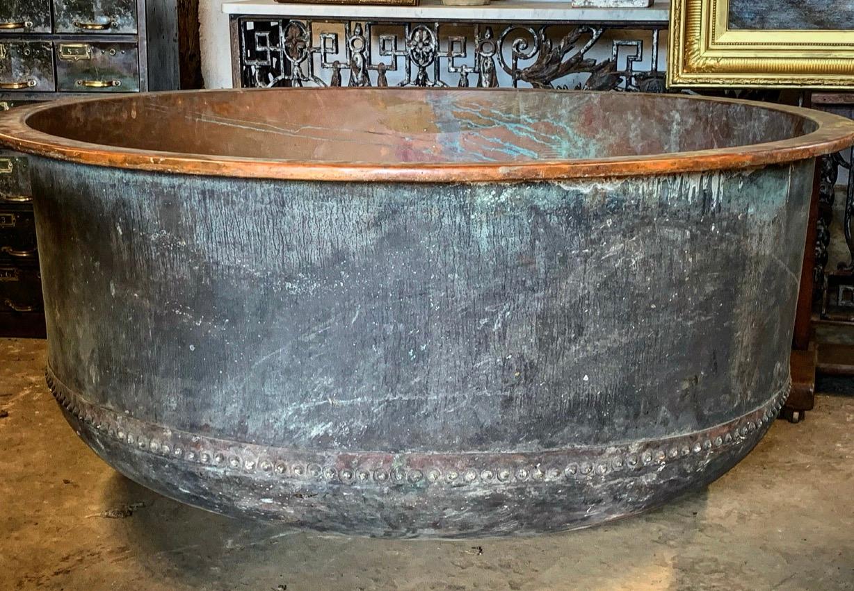 A large 19th century riveted copper cheese vat from the south of France. This will make a wonderful garden feature either as a planter or water feature. With a lovely natural verdigris. Please contact us for an accurate shipping quote.