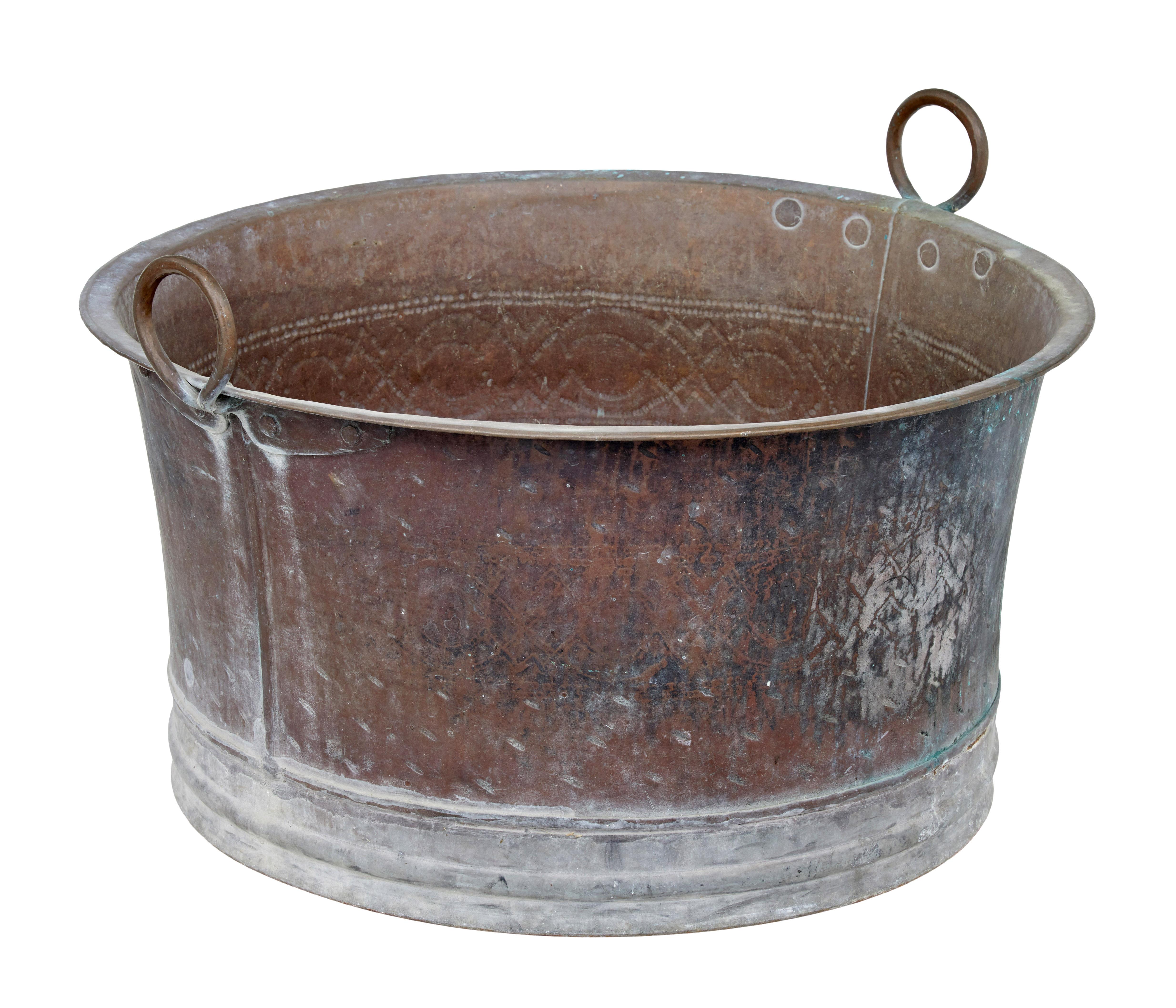 Large 19th century copper cooking vessel circa 1880.

We are pleased to offer this copper pot with its original patina that it has taken on over the years. Decorated around the outside with a hand hammered design.

Looped copper