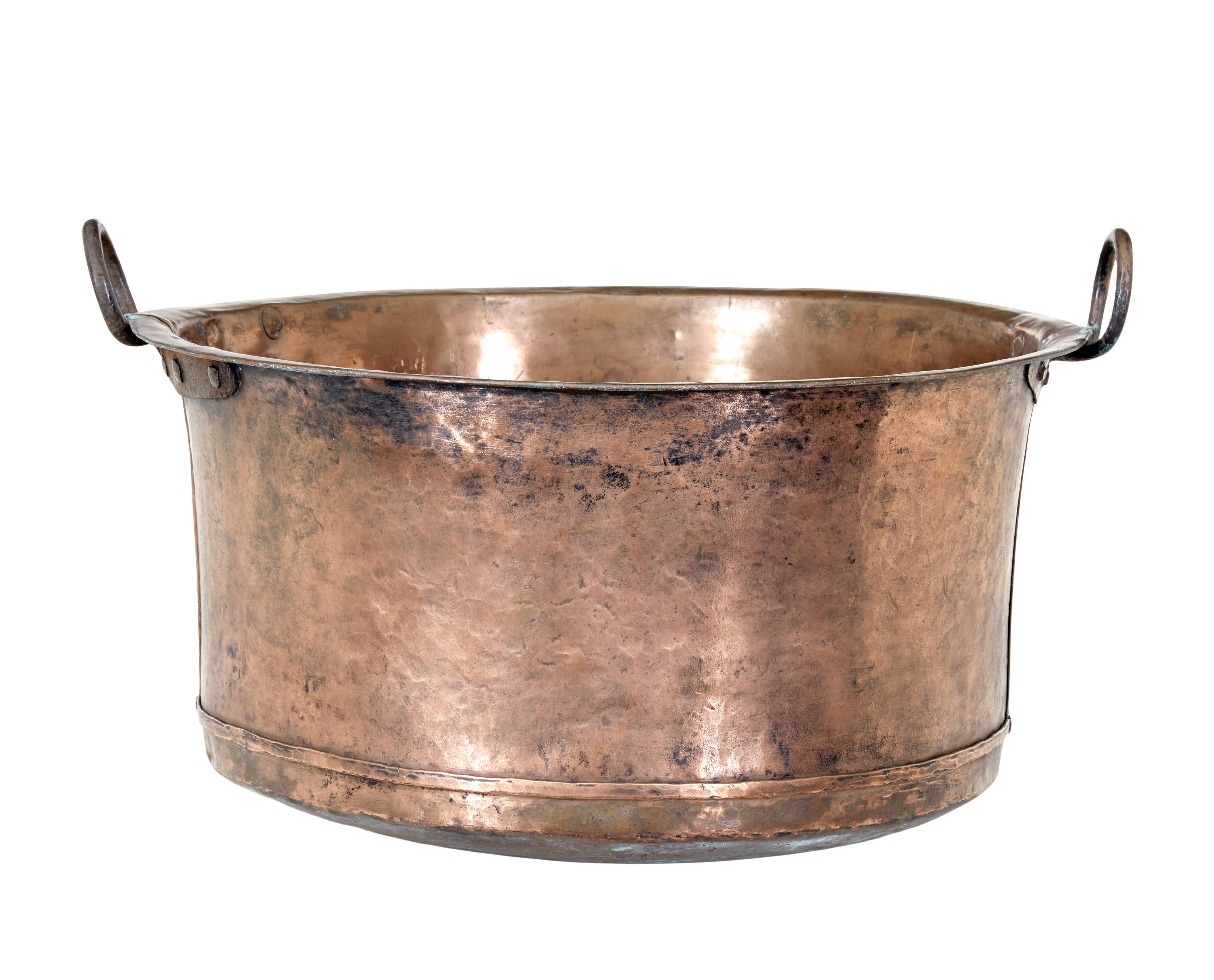 Large 19th century copper cooking vessel circa 1890.

Good quality cooking vessel with many possible uses for todays home, such as a log bin or a internal planter.

Solid copper with iron handles which have been hand rivotted on.

Expected surface