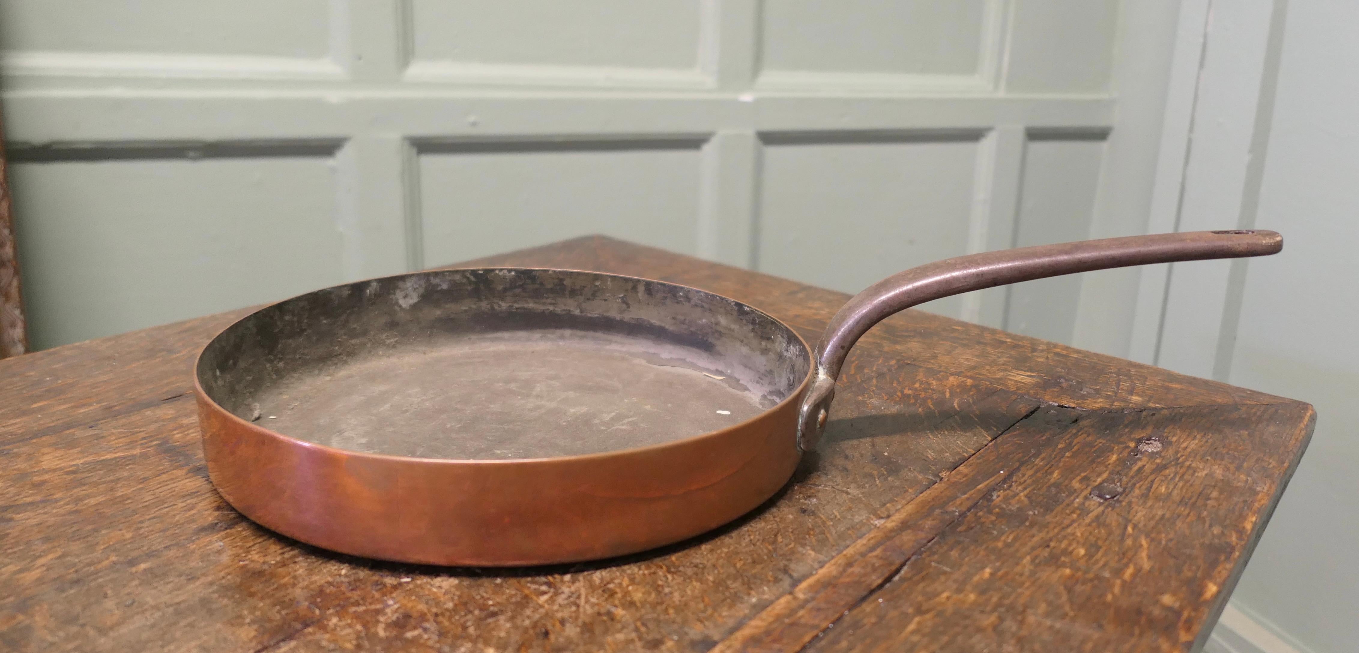  Large 19th Century Copper Frying Pan

This is a lovely looking 19th Century Frying Pan, the pan was obviously a very treasured piece,  it has a riveted iron handle, high sides and is flat bottomed
The Pan is in good condition for its age and has a