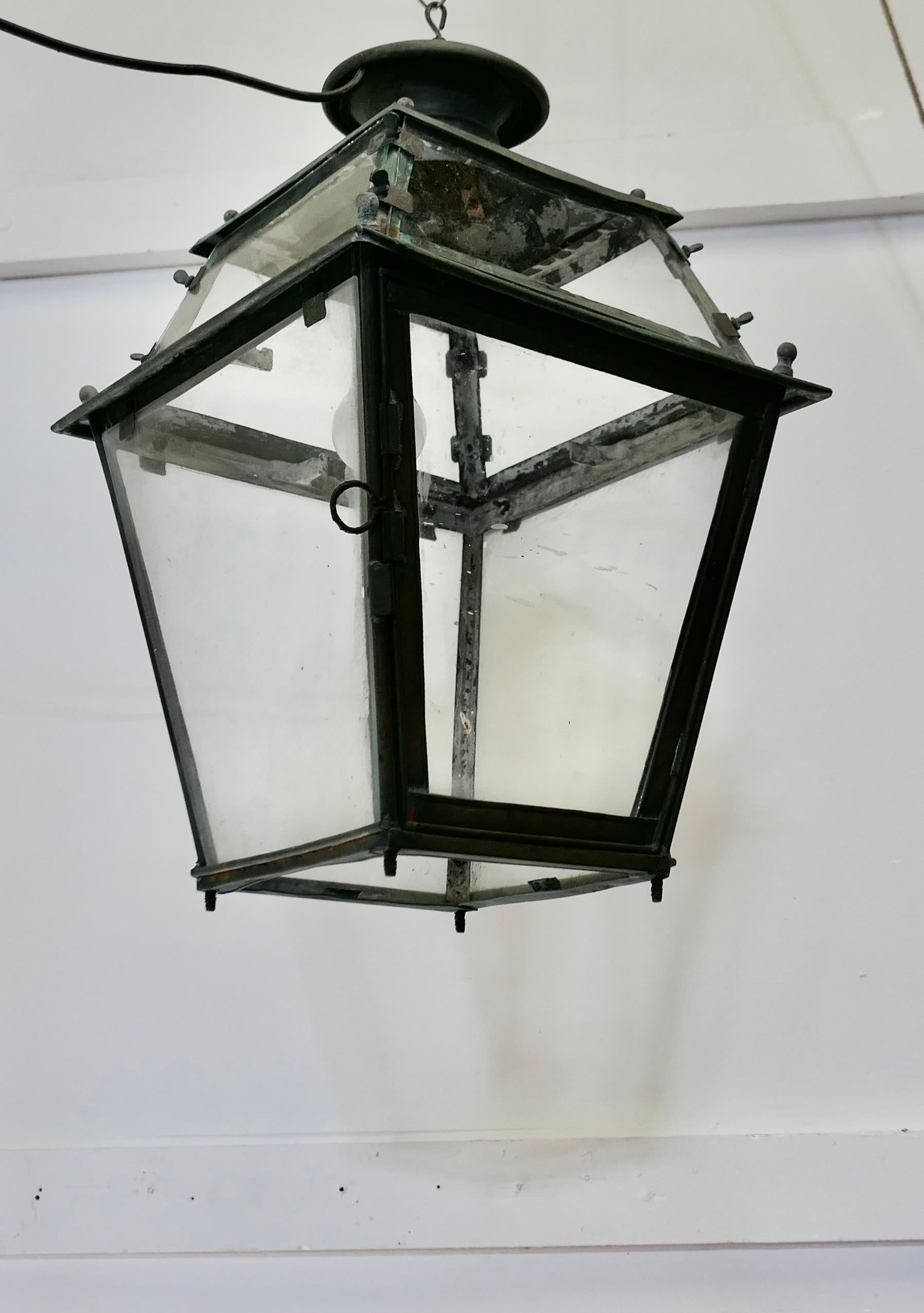 Large 19th Century Copper Hanging Lantern

This is a Large Copper Lantern it has a natural oxidised patina, the Lamp has 4 glazed sides with a door on one side, the lantern can be hung from above, it has not been wire for electricity but we have