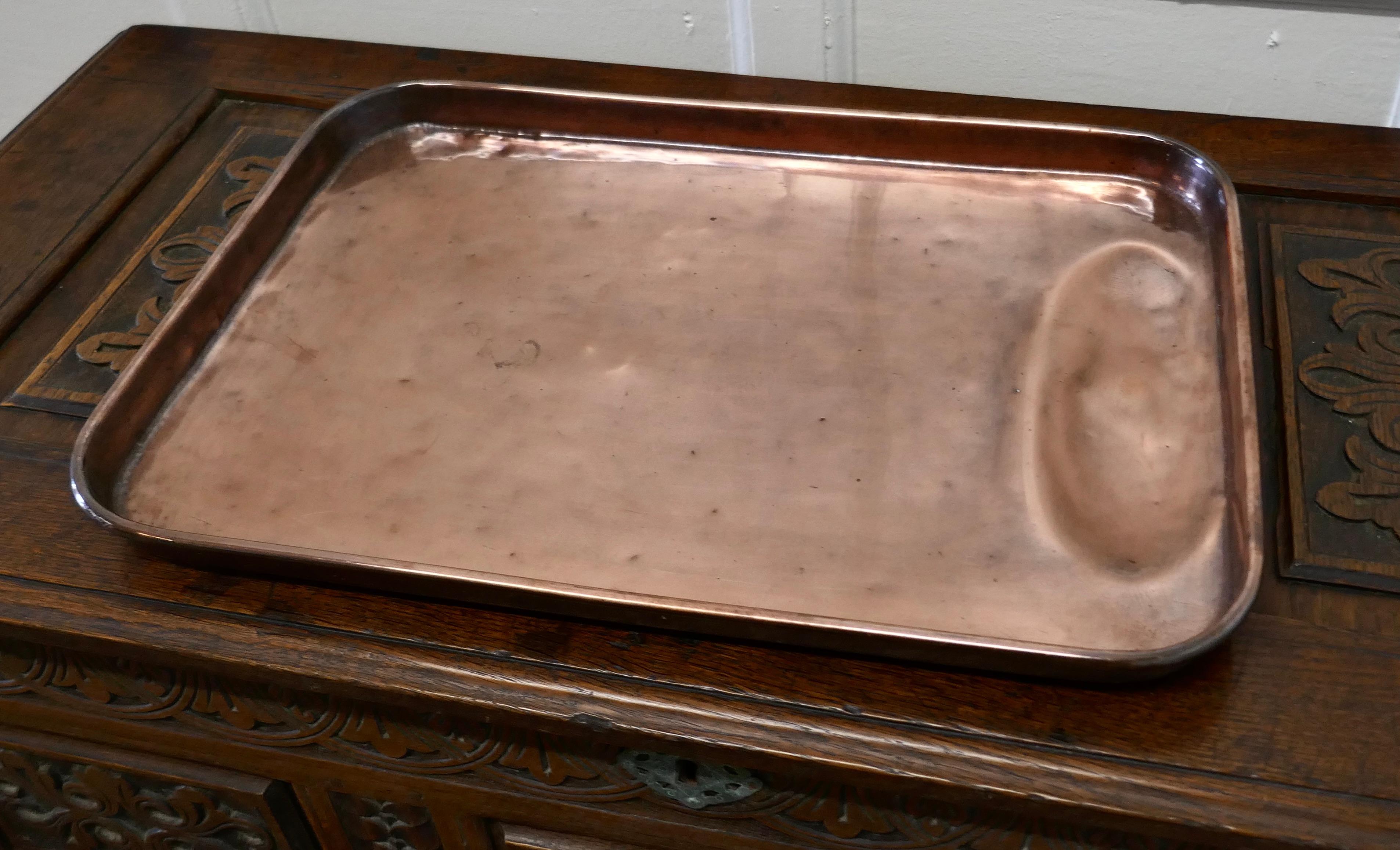 Large 19th Century copper roasting tray with gravy well

This is a lovely looking piece of Copper cookware, the tray is very rare and would have been much treasured piece
The tray has 1.5” high sides with a rolled top edge and an oval gravy well