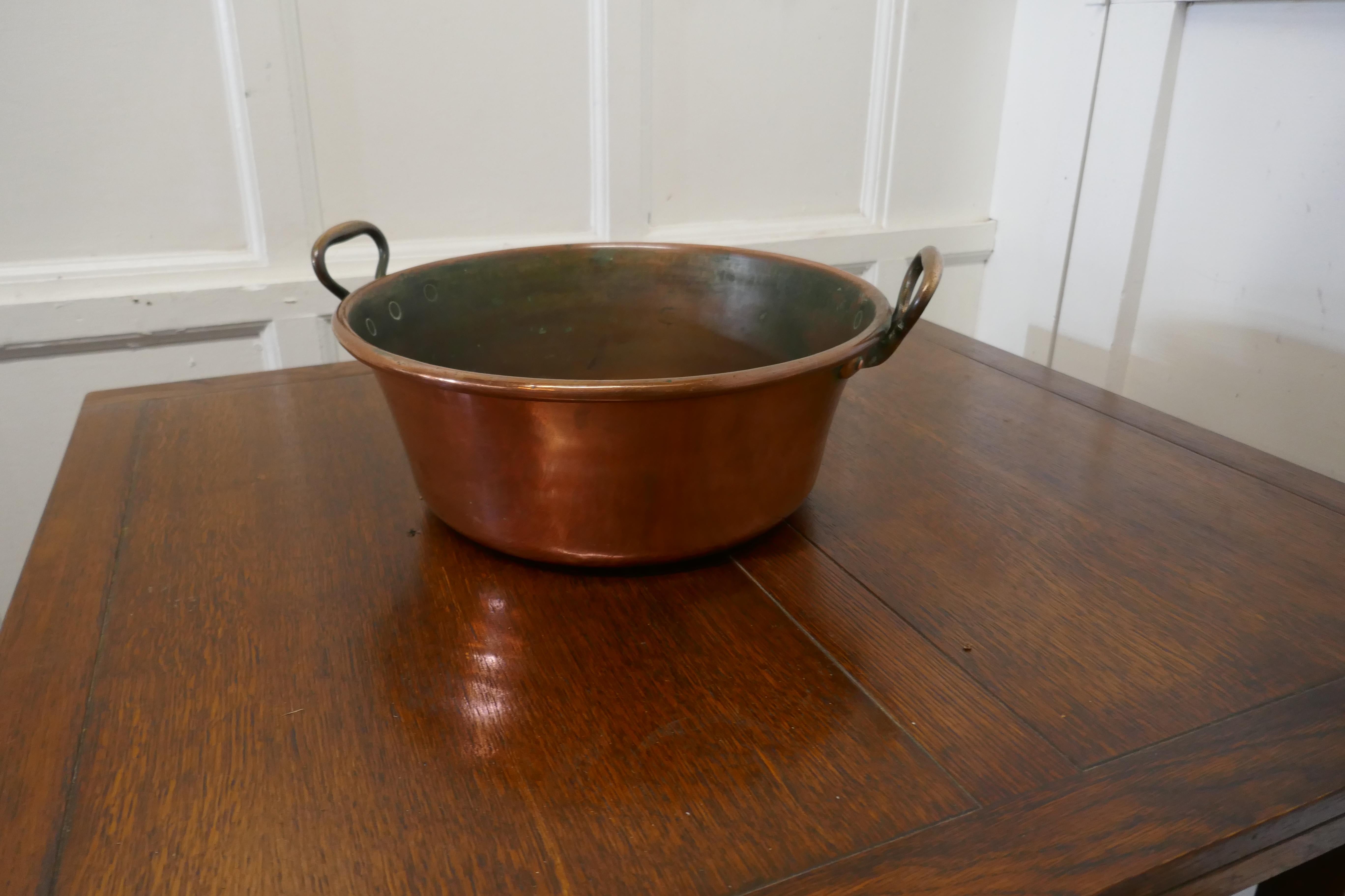 Large 19th century double handled copper pan

This is a lovely looking Pan, the pan was obviously a very treasured piece, it has original Brass handles with robust copper riveting.
 
A pan of this type would have been used in jam making, for