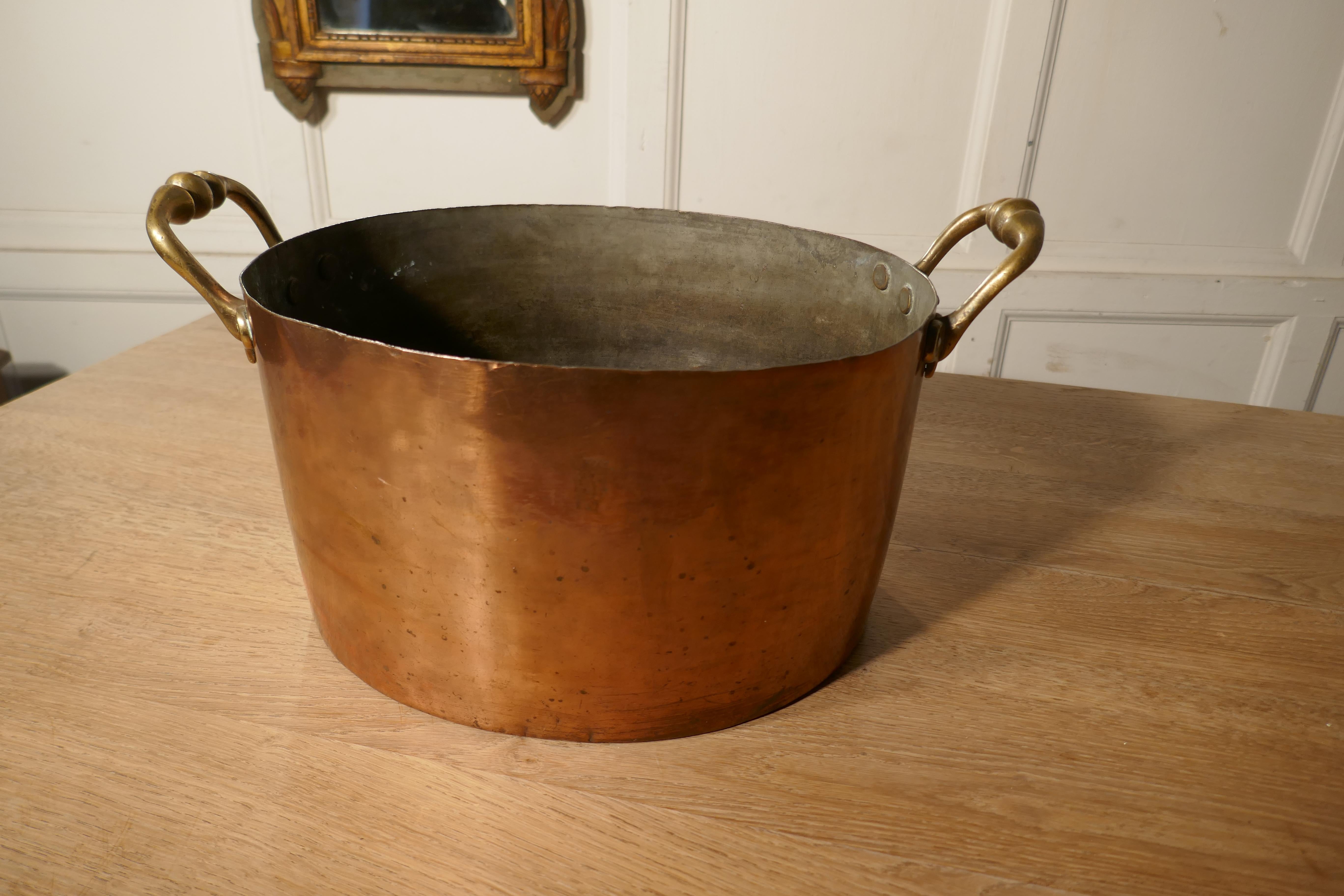 Large 19th century double handled copper pot

This is a lovely looking pot, the pan was obviously a very treasured piece, it has original Brass handles with robust copper riveting.
 
A pan of this type would have many uses around the