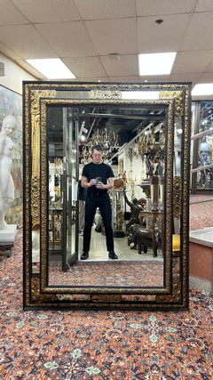 Large 19th Century Dutch Ebonized and Gilt Repousse Metal Wall Mirror