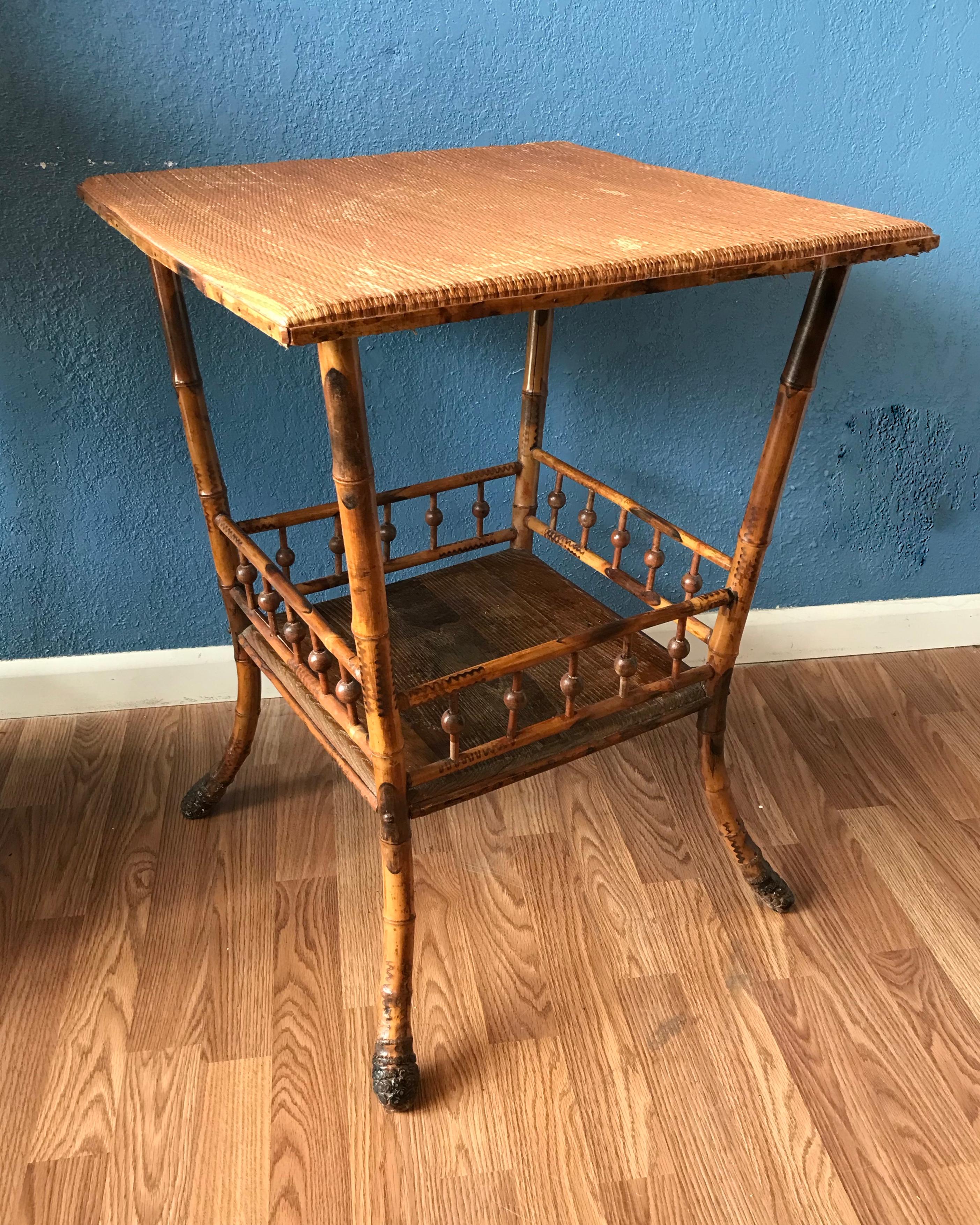 An outstanding table generously scaled
and finished with a grasss cloth top. The
table is accented with a gallery framed
bottom shelf. It is appointed with dramatic
root feet. The bottom shelf is oak.