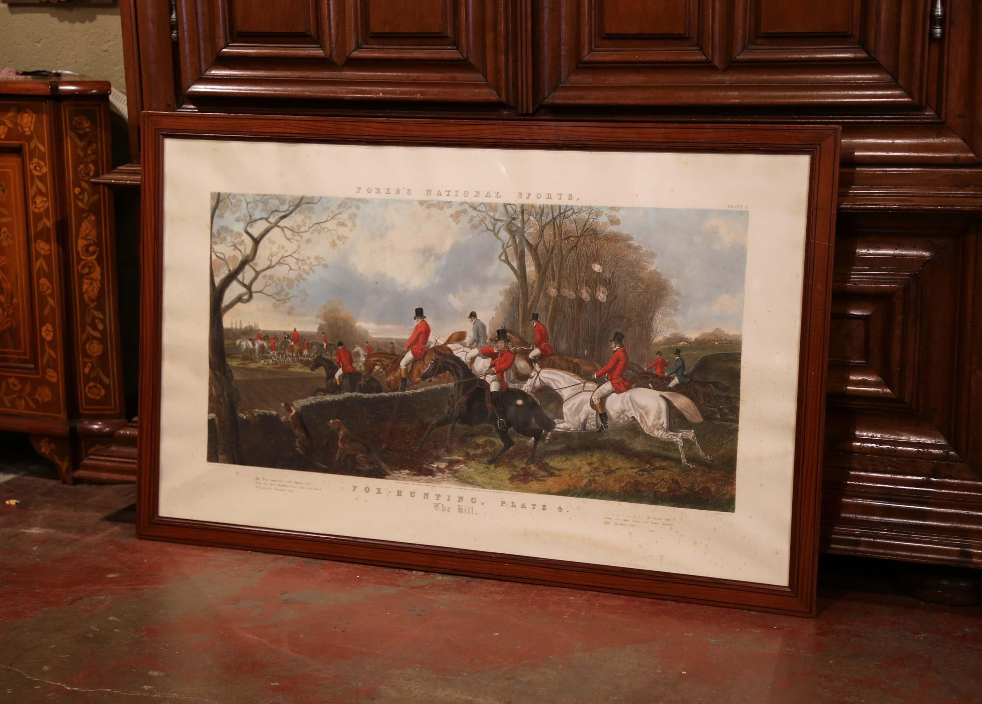 Large and colorful antique watercolor hunting scene under glass in wooden frame from England by Mess rs Fores; dated 1852, the art work features fox hunters on galloping horses with dog pack running beside them. The decorative wall hanging piece
