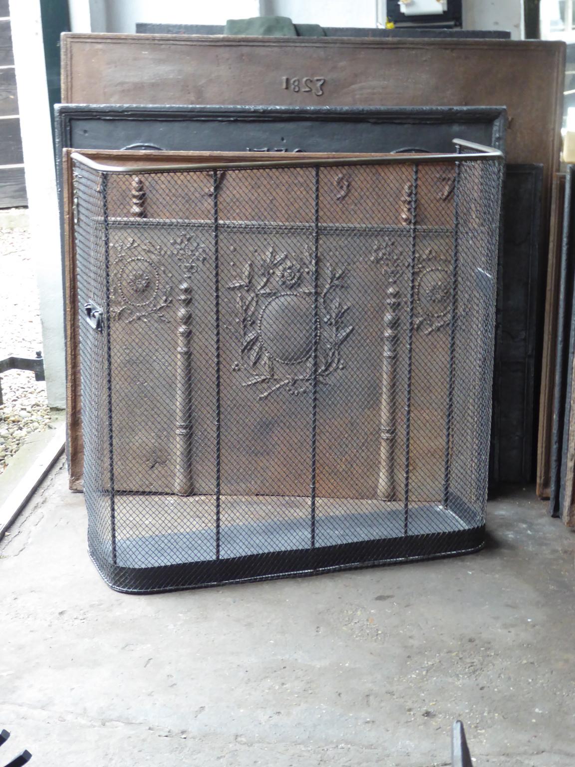 Large 19th century English Victorian fireguard, fireplace guard made of brass, iron and iron mesh. The fire guard is in a good condition and is fully functional.

All our products that weigh 66 kg / 146 lbs or more are shipped as standard