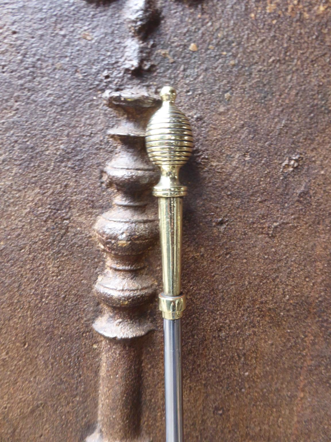 Large 19th century English Victorian fireplace shovel made of polished steel and polished brass.