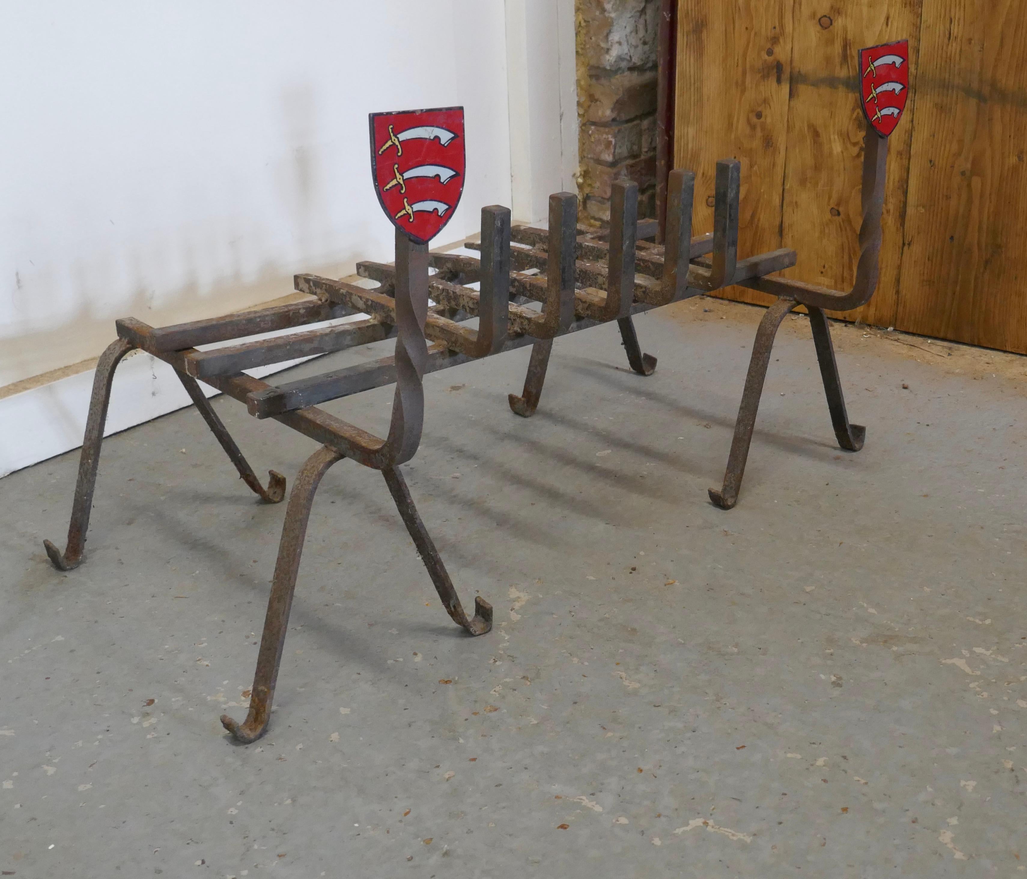 Large 19th century fire grate set with Essex Shield iron andirons 

This is a large fire grate set on Crested Andirons, the enamel crests are the Coat of Arms of Essex in England
Wonderful large pieces in sound condition
The Dogs are 21” high,