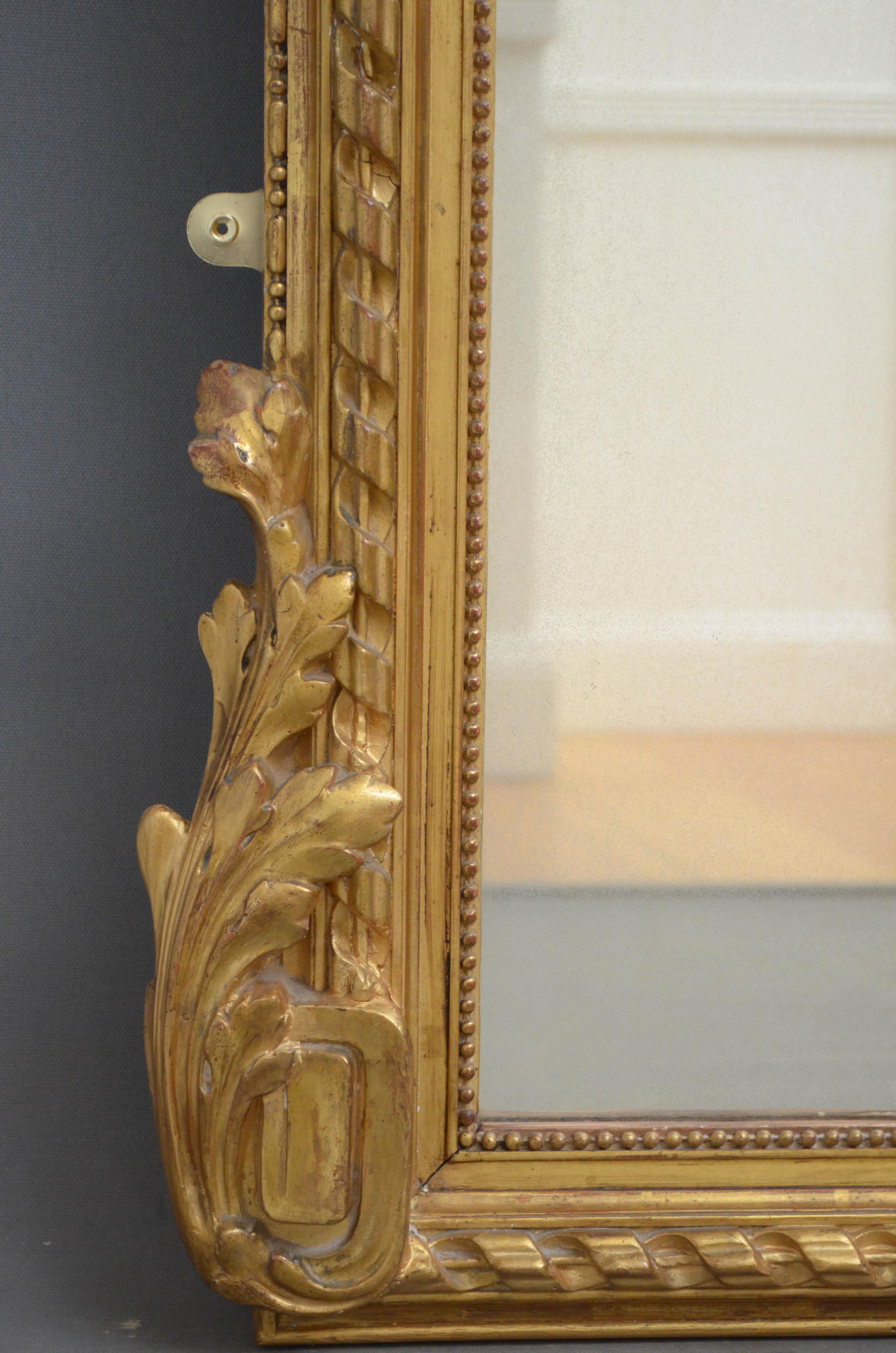 Sn4771 large floor standing or wall hanging antique gilded mirror, having original glass with some foxing in finely carved and swag decorated gilt frame. This mirror retains its original glass and gilt, all in excellent home ready condition, circa