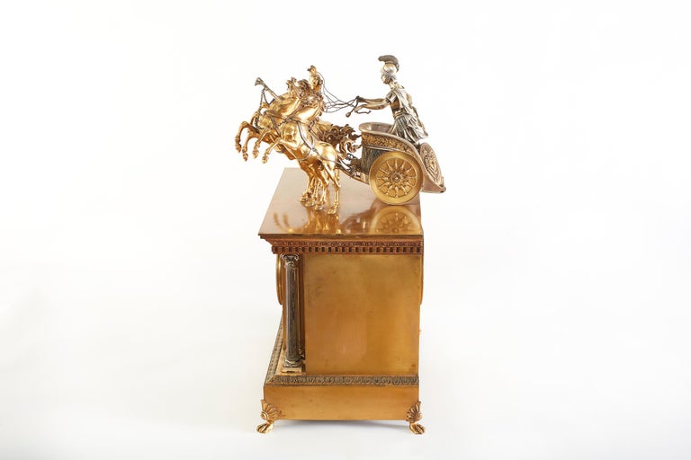 Large 19th century French bronze figural chariot clock with 5 inches porcelain dial and fancy pierced gilt hands with brass spring driven movement. The clock has a half hour strike on a coiled gong and original pendulum w/ matching numbers. In a