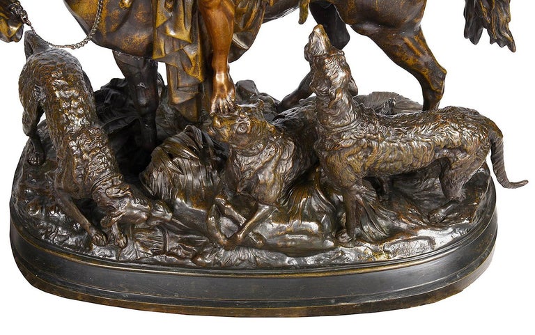 A large and impressive 19th century French bronze statue of an Arab hunter on horse back, surrounded by his hounds.