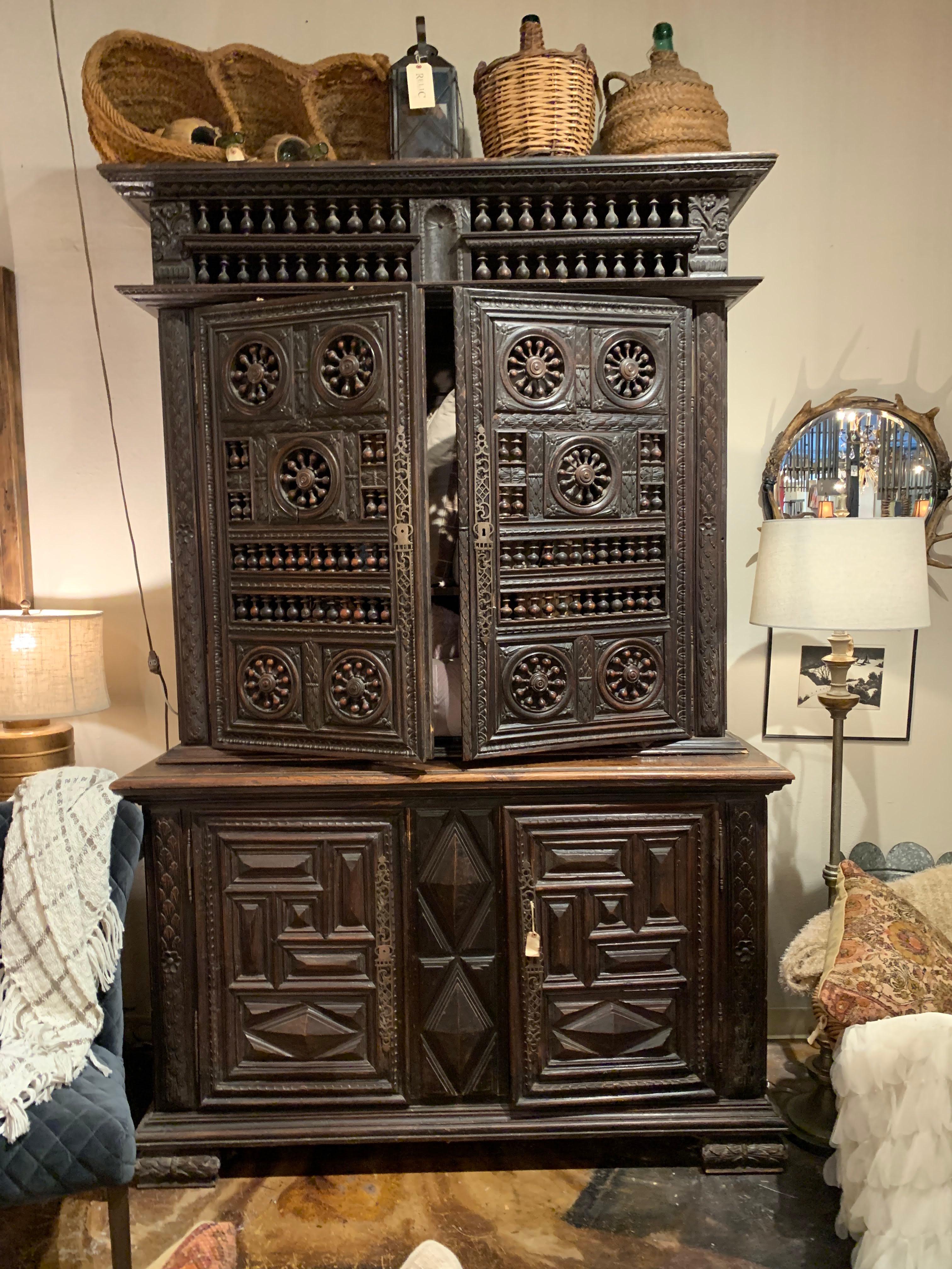 The extraordinary antique double buffet is from Brittany / Normandy region, France. It was made in the early 1800 (1820-1850). The heavy carving, turned wheel spokes and incredible detail show how much craftsmanship and detailed work went into