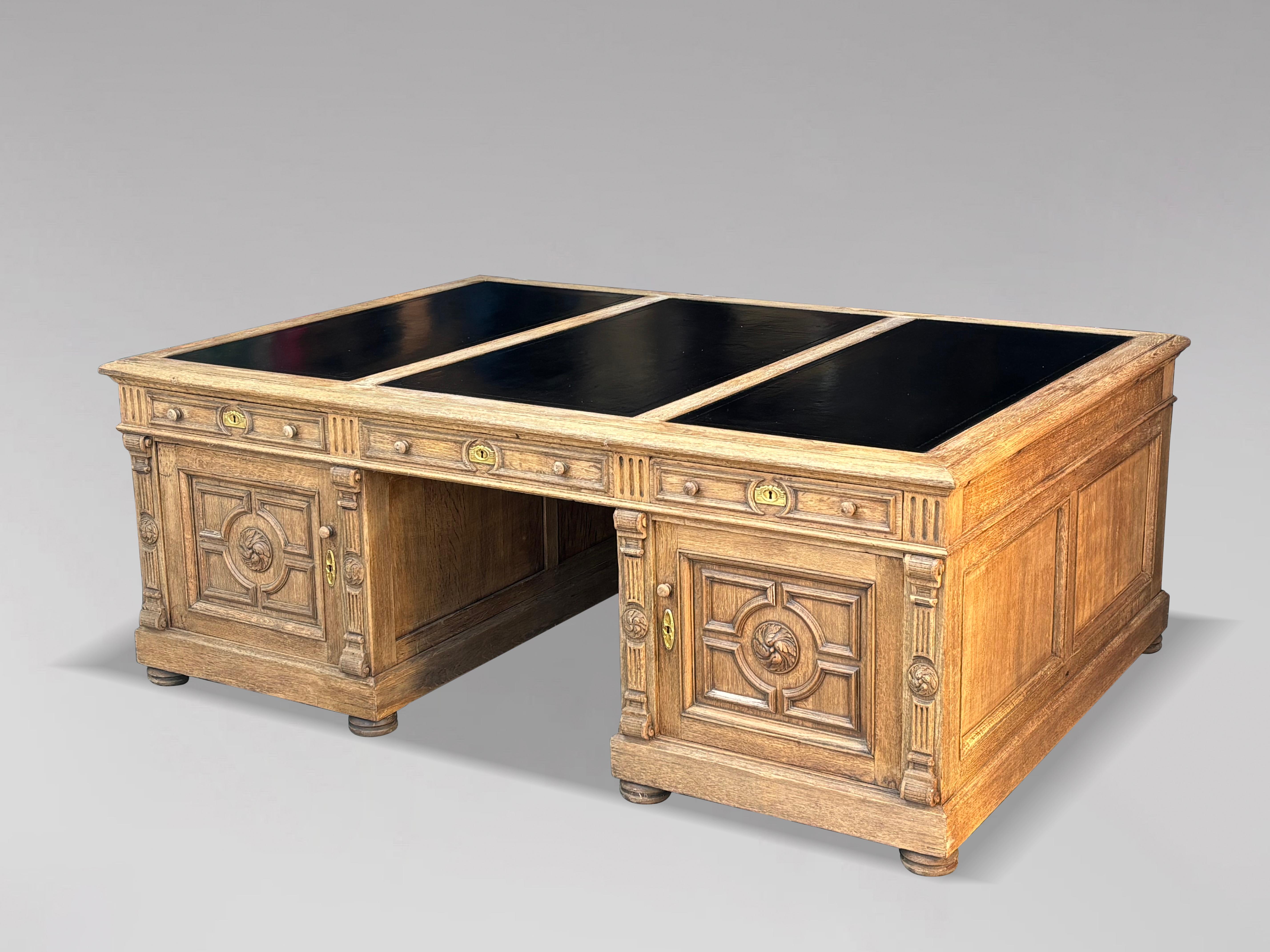 This stunning mid-19th-century French oak partners desk is a masterpiece of design and functionality, featuring a newly tooled black leather writing surface and ample storage, making it both a practical and aesthetic addition to any room.
The desk’s