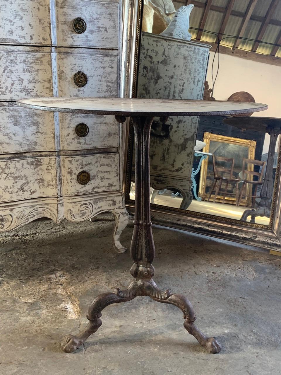 A beautiful quality and rare 19th century bistro table from France. Made from heavy cast iron with an original enamel top. Supported on 3 beautiful Lion shaped legs.