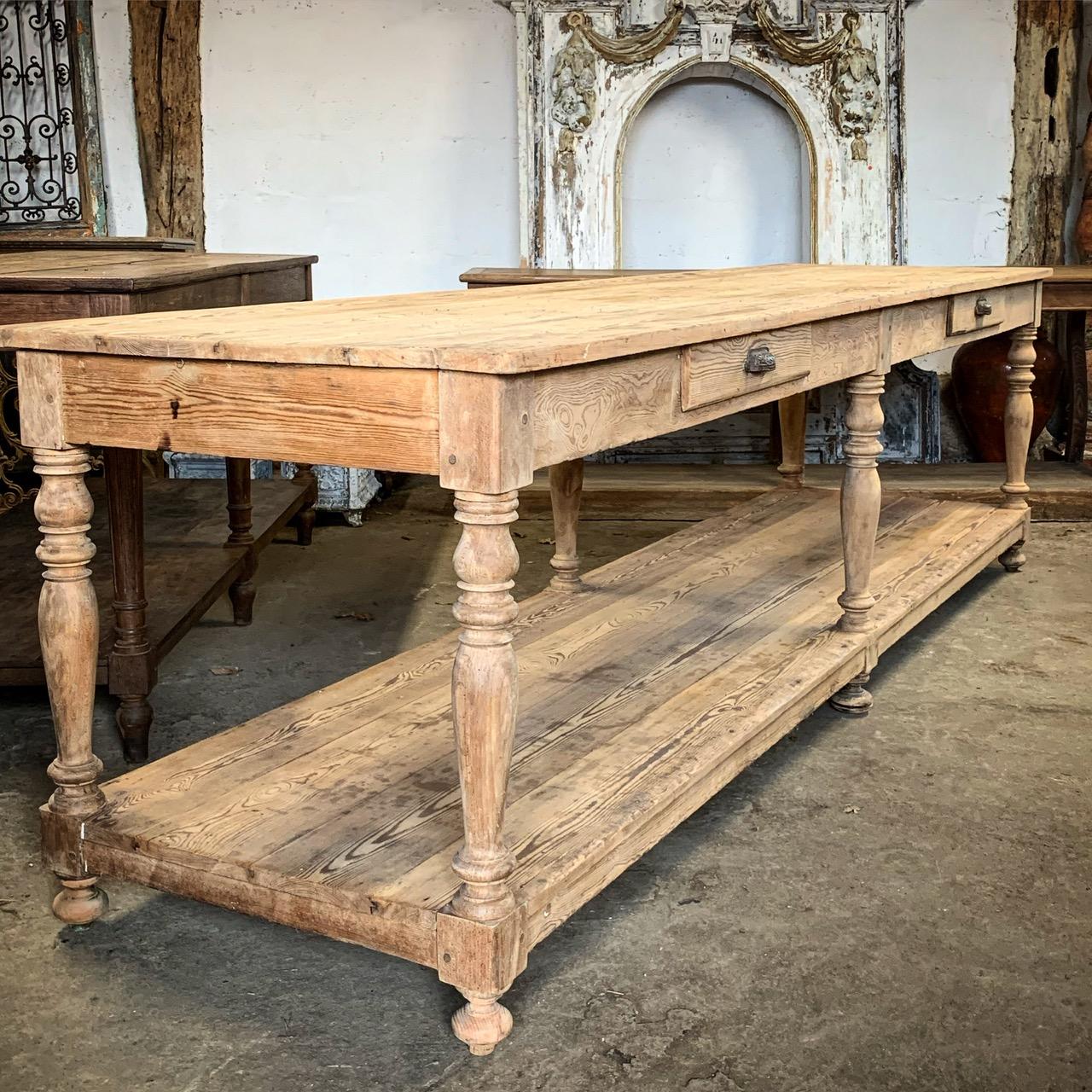 A lovely 19th century French pine drapers table with two drawers on one side.  The wood has a nice aged colour and wear form age and use. On nice turned legs giving it a wonderful look.