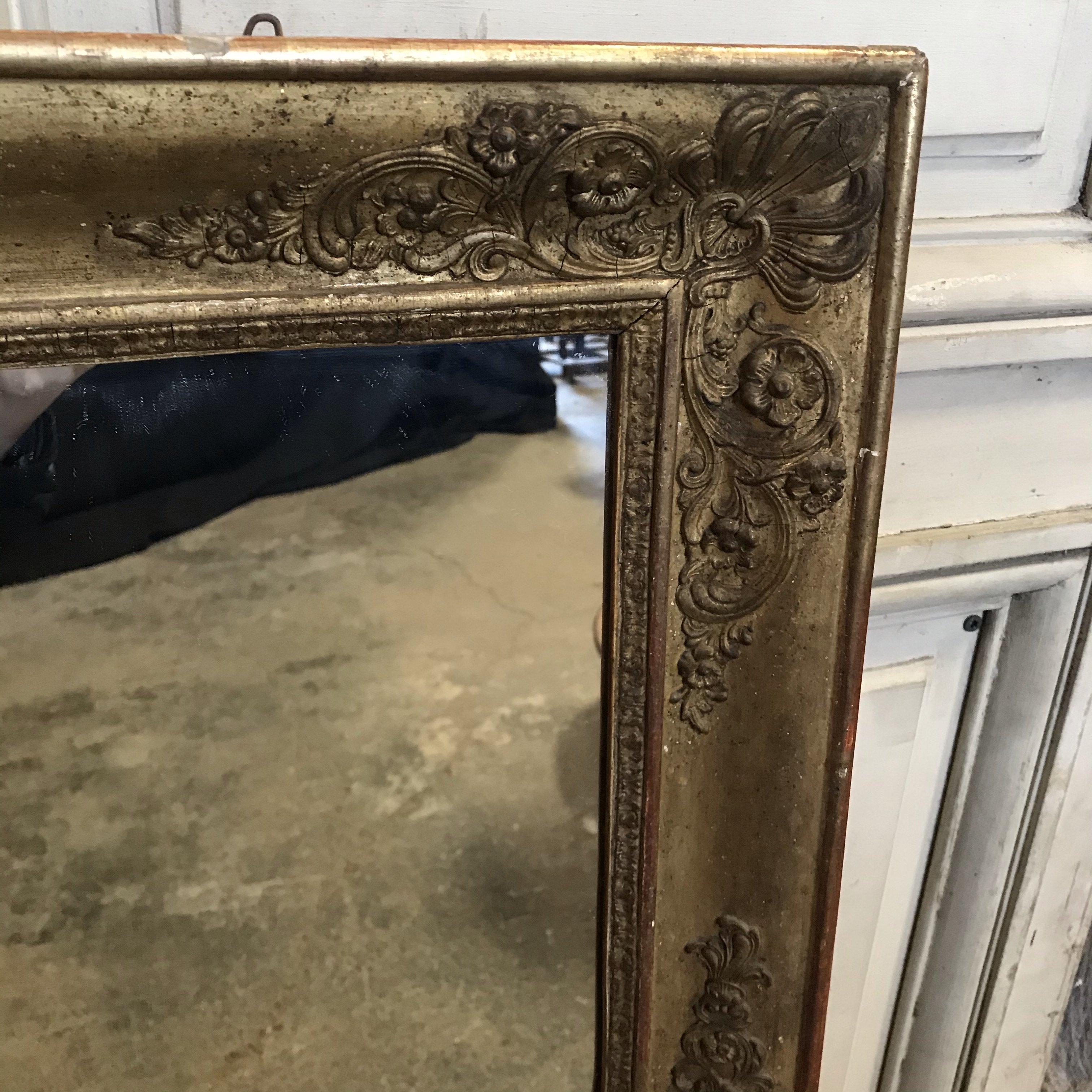 Classic early 19th century large giltwood mirror with pretty decoration on the frame and original wooden back.
#3457.