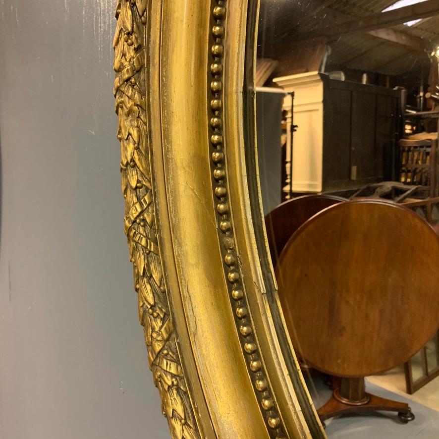 Large 19th Century French Gilt Oval Mirror with Original Bevelled Mirror Plate In Good Condition In Uppingham, Rutland