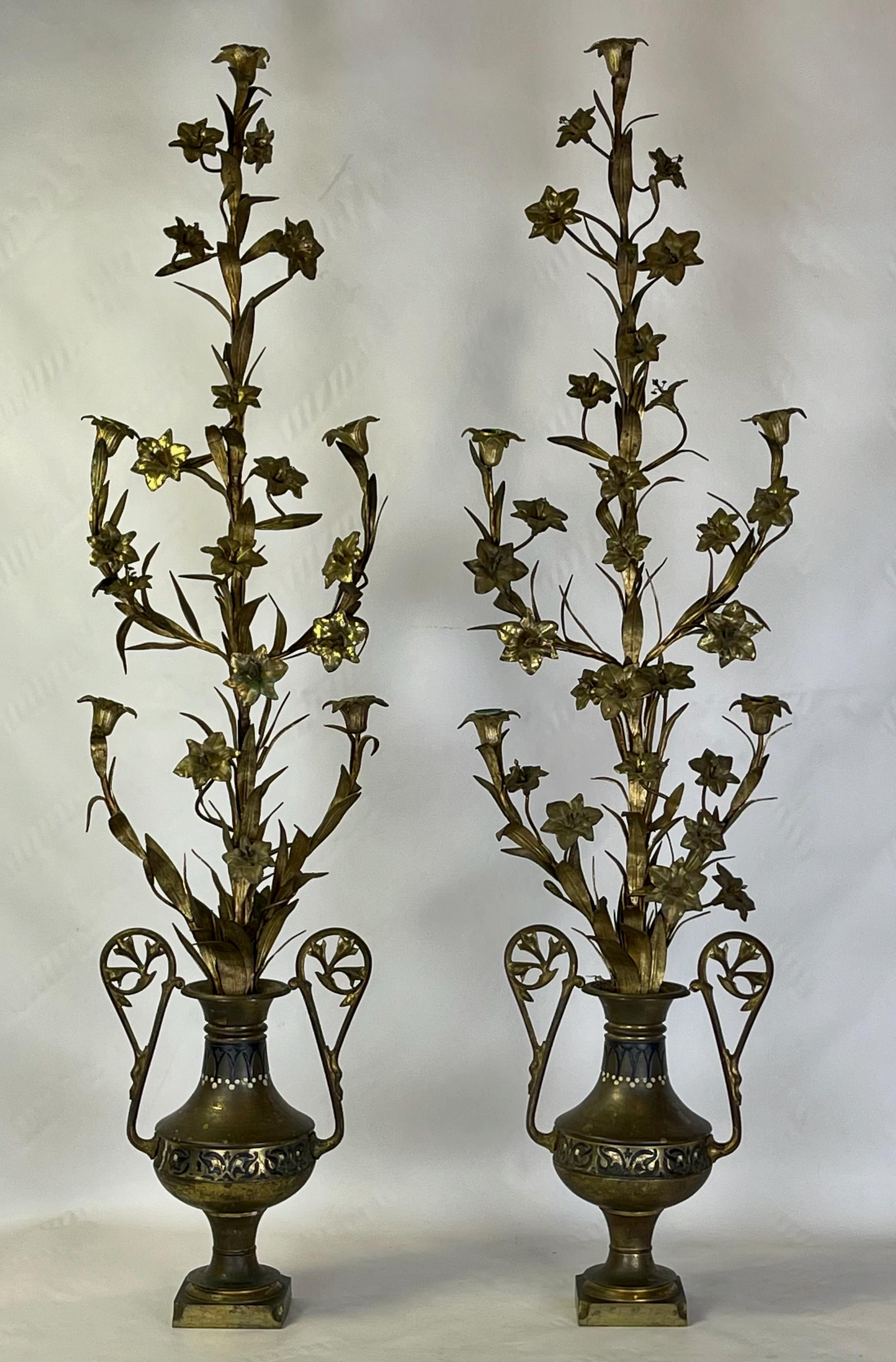 An exceptionally tall pair of late 19th C. French gilt tole five light candelabra in the form of lilies arranged in a vase.