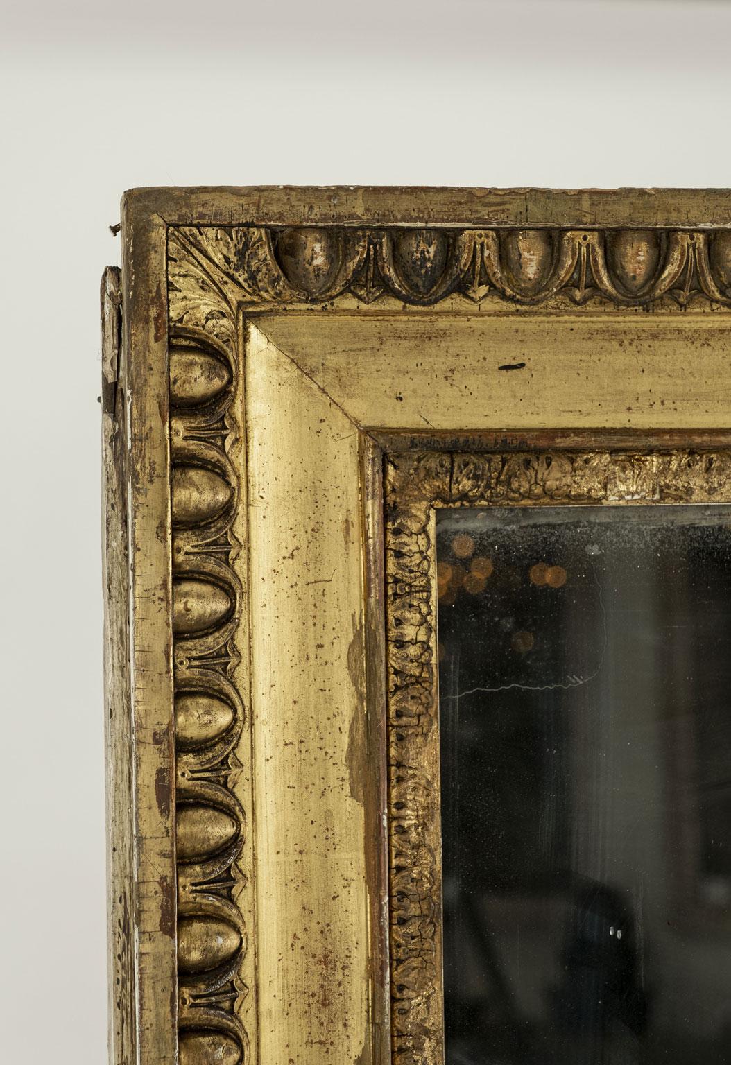 Large 19th century French giltwood mirror with egg and dart decoration. Original - or early - mercury mirror plate with small losses of silvering on reverse. Small amounts of subtle diamond dust effect around edges.