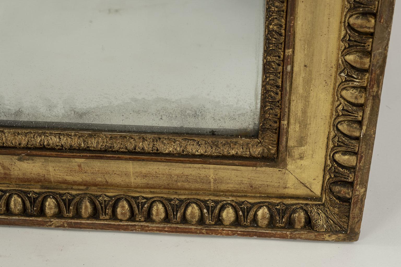 Large 19th century French giltwood mirror with egg and dart decoration. Original - or early - mercury mirror plate with small losses of silvering on reverse. Small amounts of subtle diamond dust effect around edges.