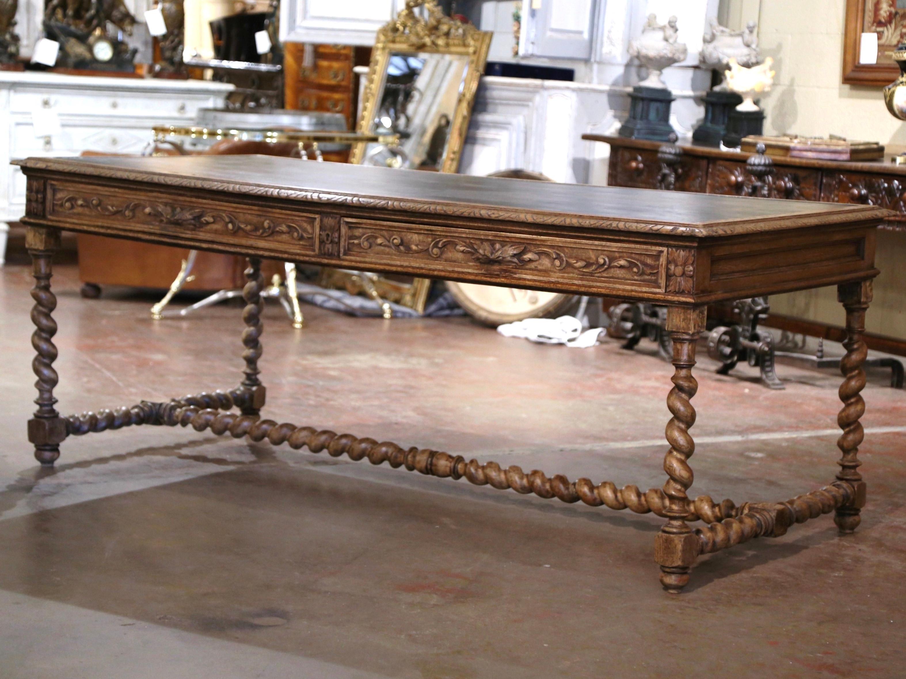 Decorate a study or office with this elegant antique table desk. Crafted in Northern France, circa 1870, the large writing table stands on carved barley twist legs ending with turned feet, and connected with an elegant stretcher at the base. The