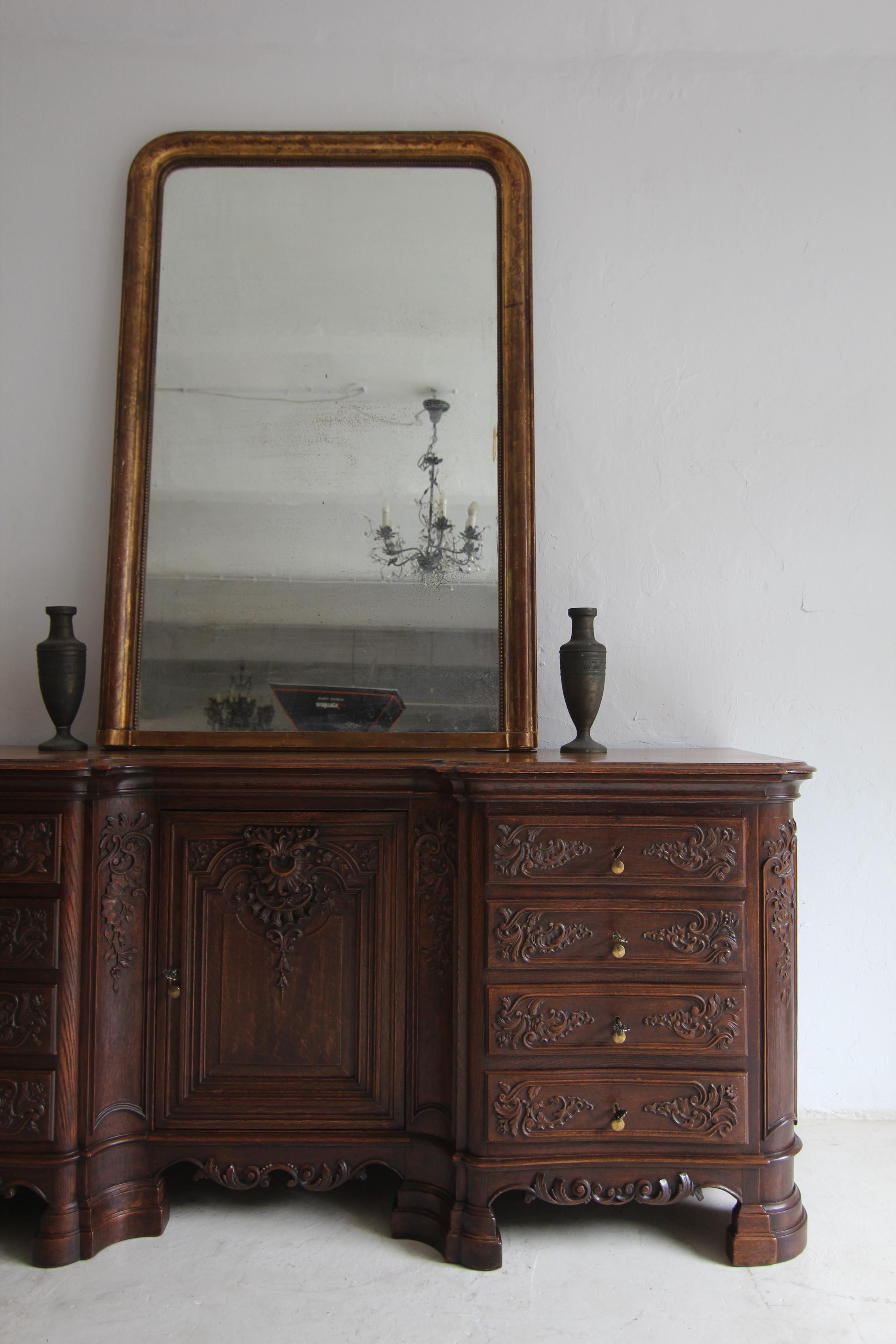Exceptionally large Louis Philippe mirror from France, circa 1850.

A representative piece above a mantelpiece, on a chest of drawers, a sideboard or a console table.

Pine wood and gesso with original poliment gilding and vine decoration. Profiled