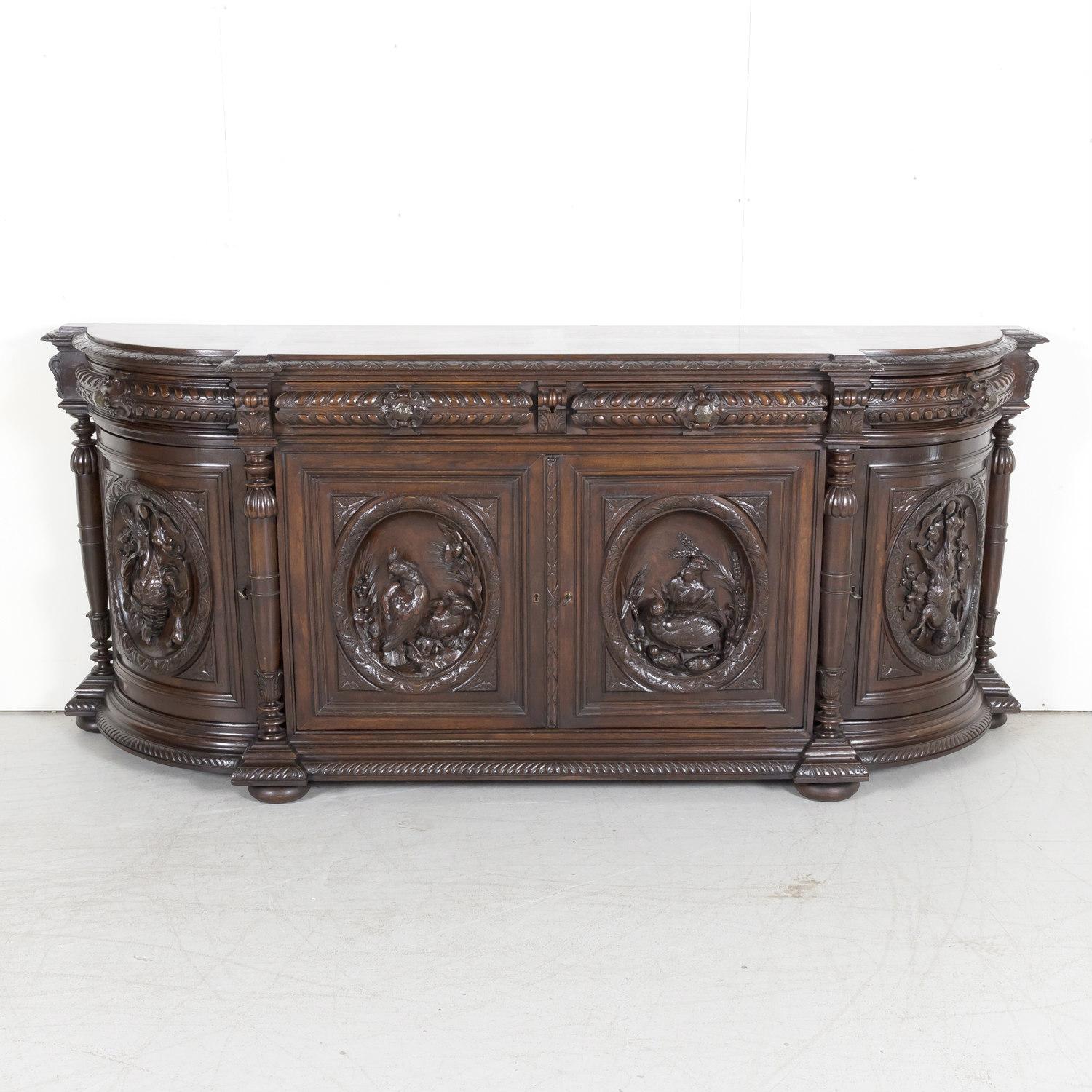 An impressive large 19th century Louis XIII style demilune hunt enfilade buffet handcrafted from solid old growth oak by an expert ébéniste in the Normandy region, circa 1880s. This handsome French Renaissance buffet found in a hunting lodge near