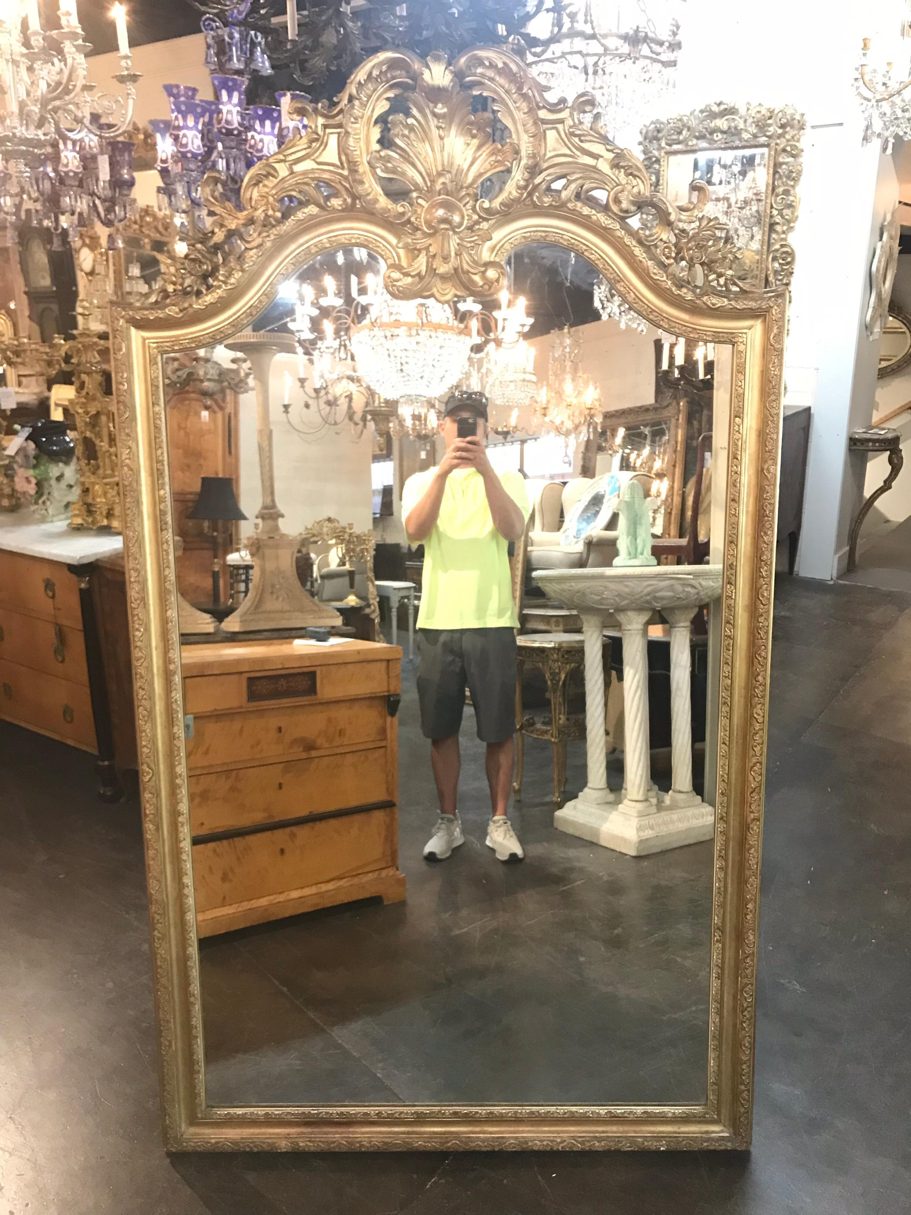 Very fine French Louis XVI Style giltwood mirror. With carved crest and exceptional gilding. Ready to make a statement in a fine home. Please reach out with any questions.