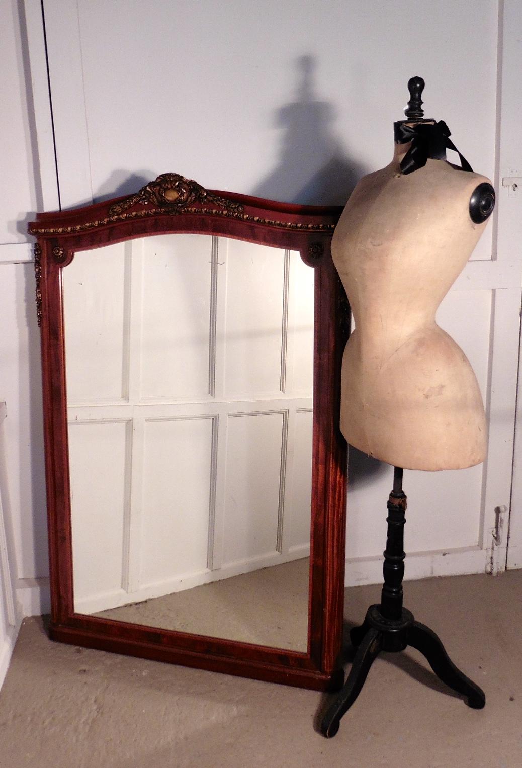 Large 19th century French mahogany and ormolu wall mirror 

This a very attractive piece, it has a 6” wide inlaid flame mahogany frame with an arched top, the mirror has attractive ormolu mounts to the corners and the cornice and it is in