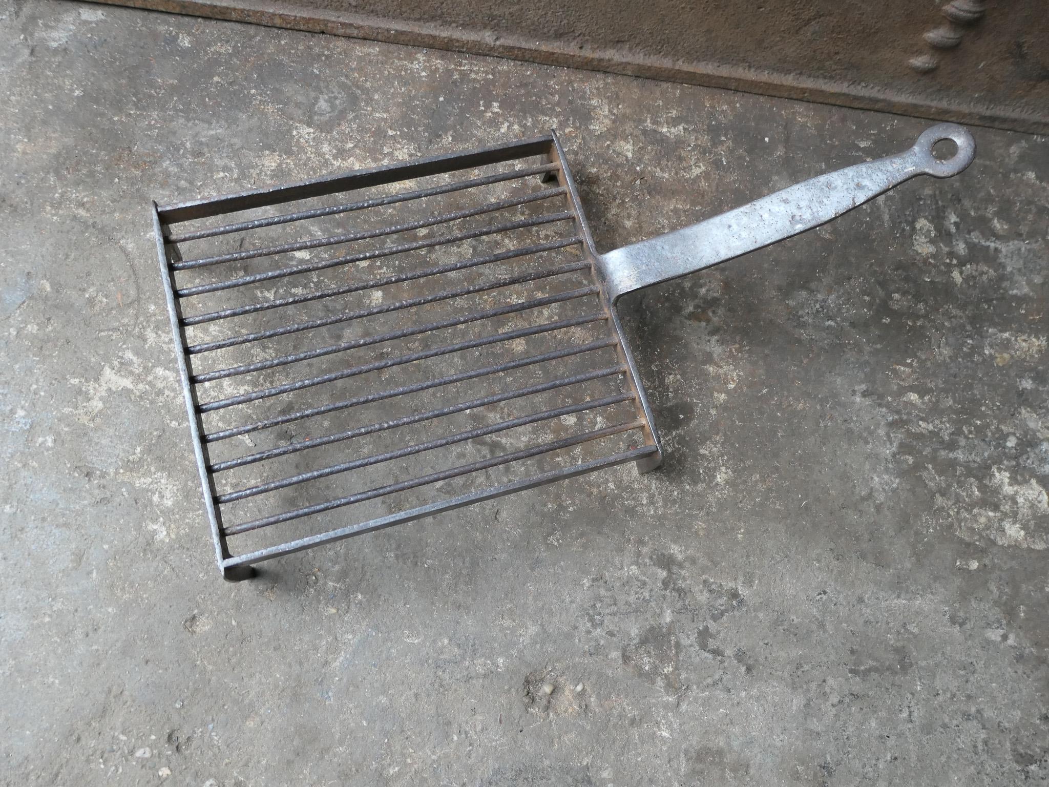 Large 19th century hand forged French gridiron, made of wrought iron. It is used to grill small pieces of meat quickly over the fire. Sometimes they are put in the fire or else on a trivet, depending on the size of the fire. The gridiron is in a