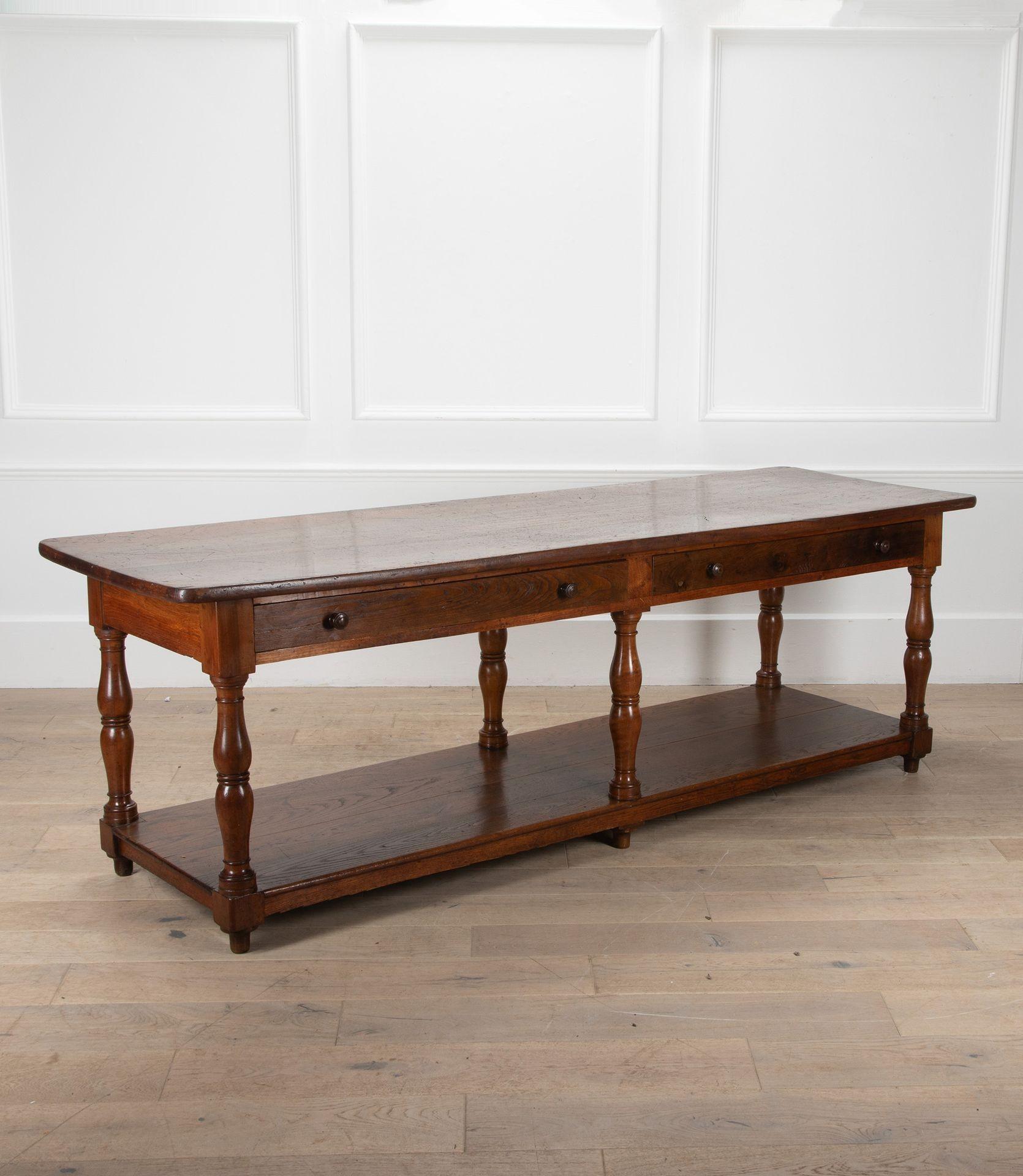 A wonderful 19th Century French drapers table.
With two drawers and featuring an exceptional rectangular top, with a beautifully aged patina.
Finished on six turned baluster legs and a lower open shelf for added storage or display.
This piece would