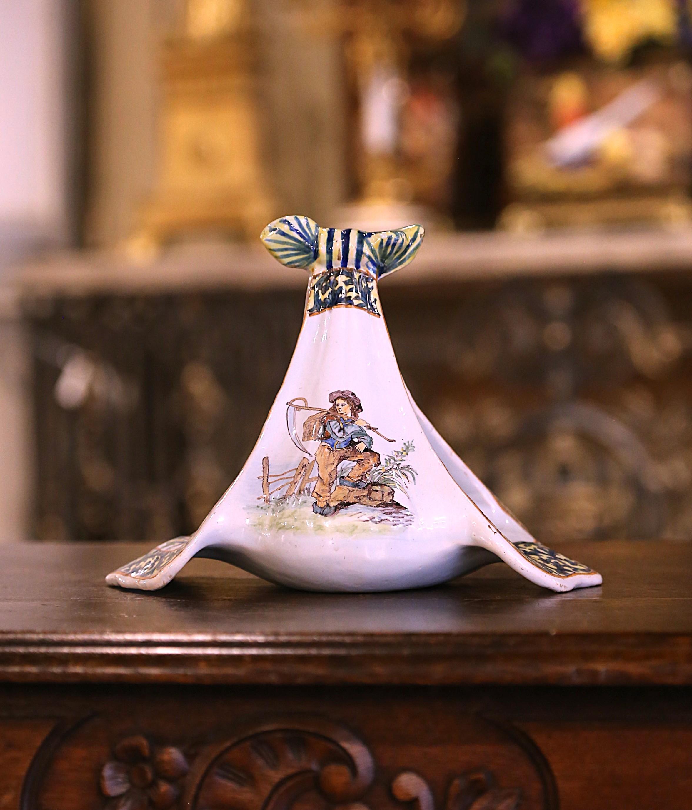Enhance your shelf, dining table, or kitchen island with this exquisite antique Quimper centerpiece by Porquier-Beau, crafted in France circa 1895. This hand-painted faience dish boasts a striking heraldic crest at its base, featuring a crowned