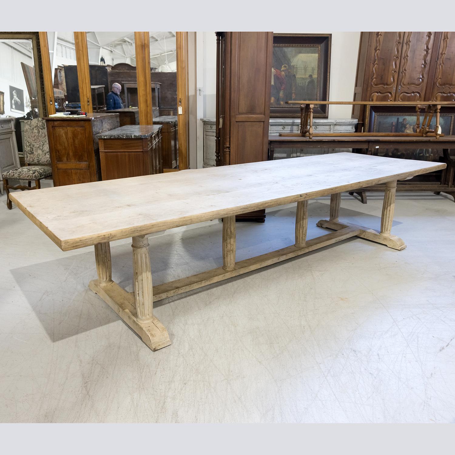 A 19th century French Provençal trestle dining table handcrafted by talented artisans near Avignon of solid oak that's been bleached or washed to a natural finish and hand waxed to a beautiful patina, circa 1890s. Having a thick rectangular solid