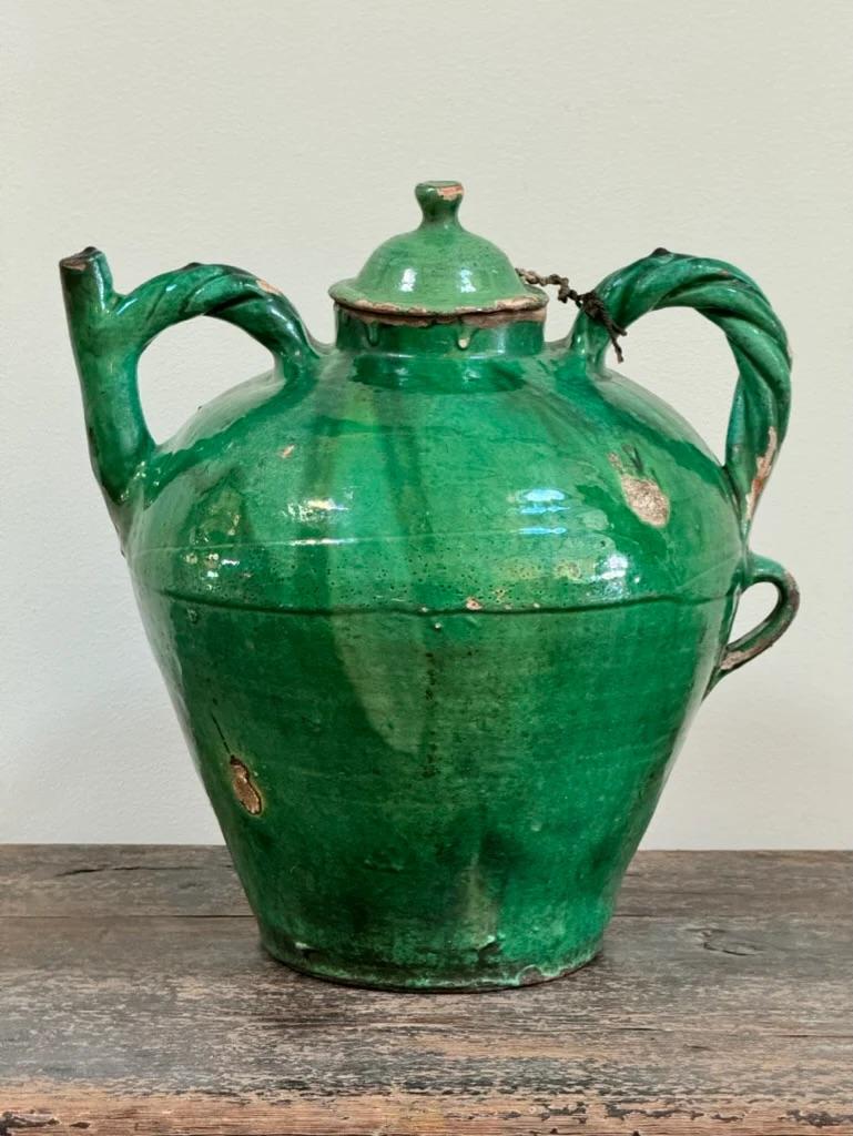 Rare  19th Century French Provincial green-glazed pottery jug having two rope-twist handles and lid.  Having striking form, particularly with the twisted handles, and in good condition.


