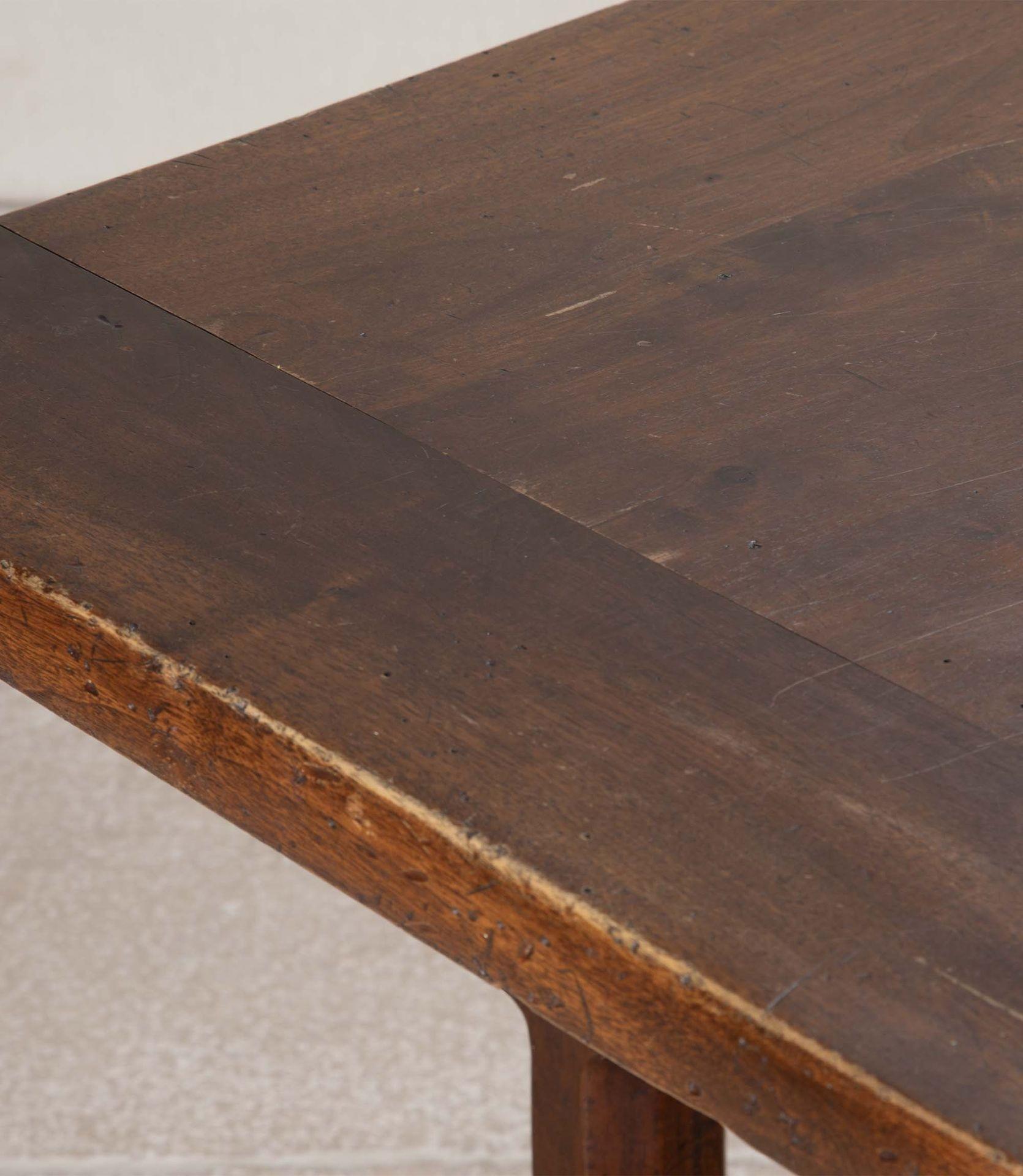 19th Century French generous fruitwood refectory table. 
With a lovely worn stretcher and carved legs. Will seat 10-12 people. 
With a later replaced top.