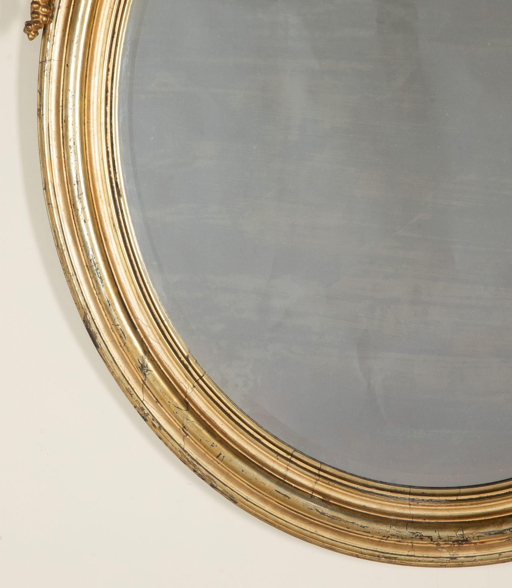 Large late 19th Century French Renaissance style oval mirror.

With elaborate carved giltwood fretwork pediment. 

With original gilding and original bevel edge mirror plate. Circa 1890.