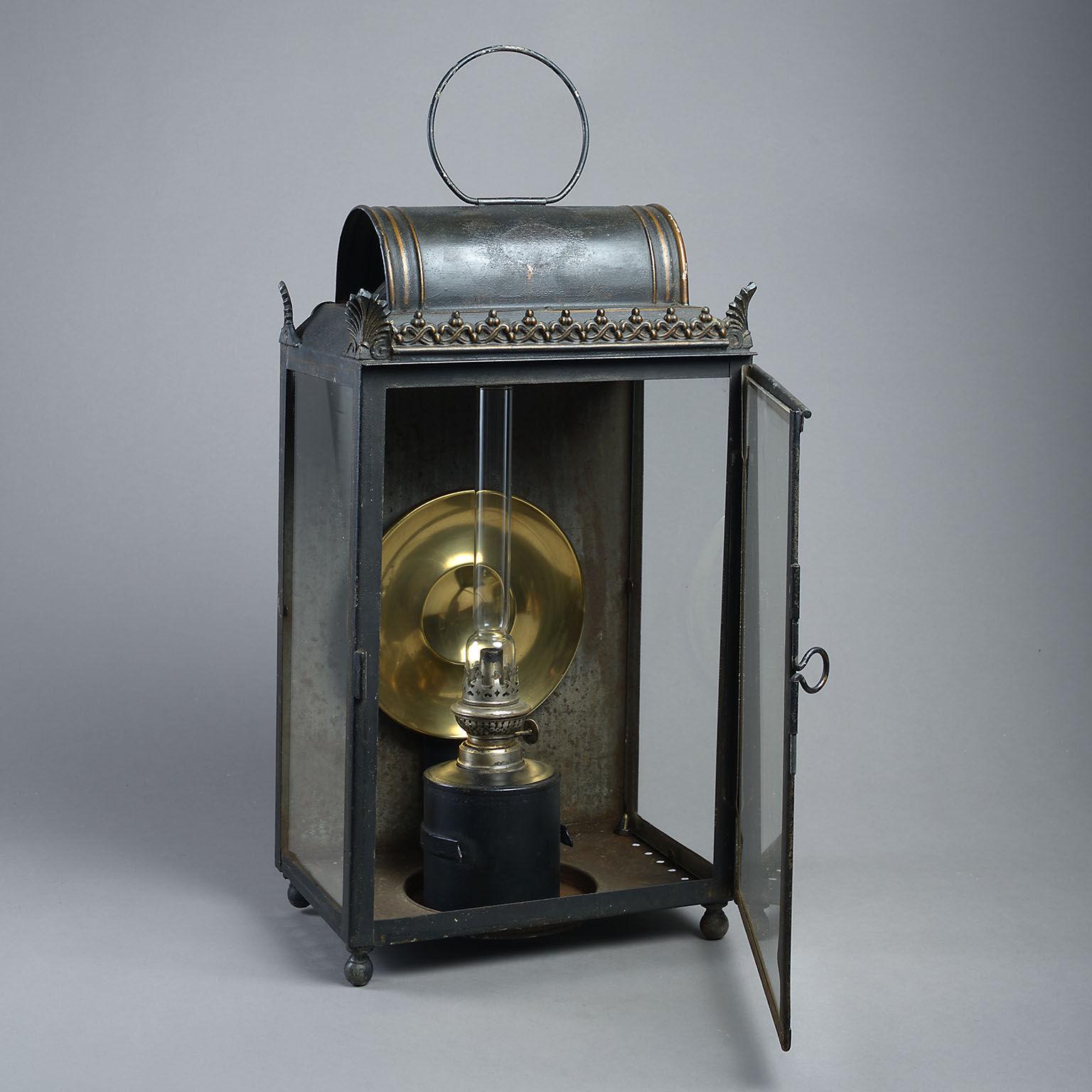 The curved top with cast anthemion decoration to the corners above an opening glazed door containing the original polished brass reflector and raised on ball feet. The internal oil burner is a period replacement.