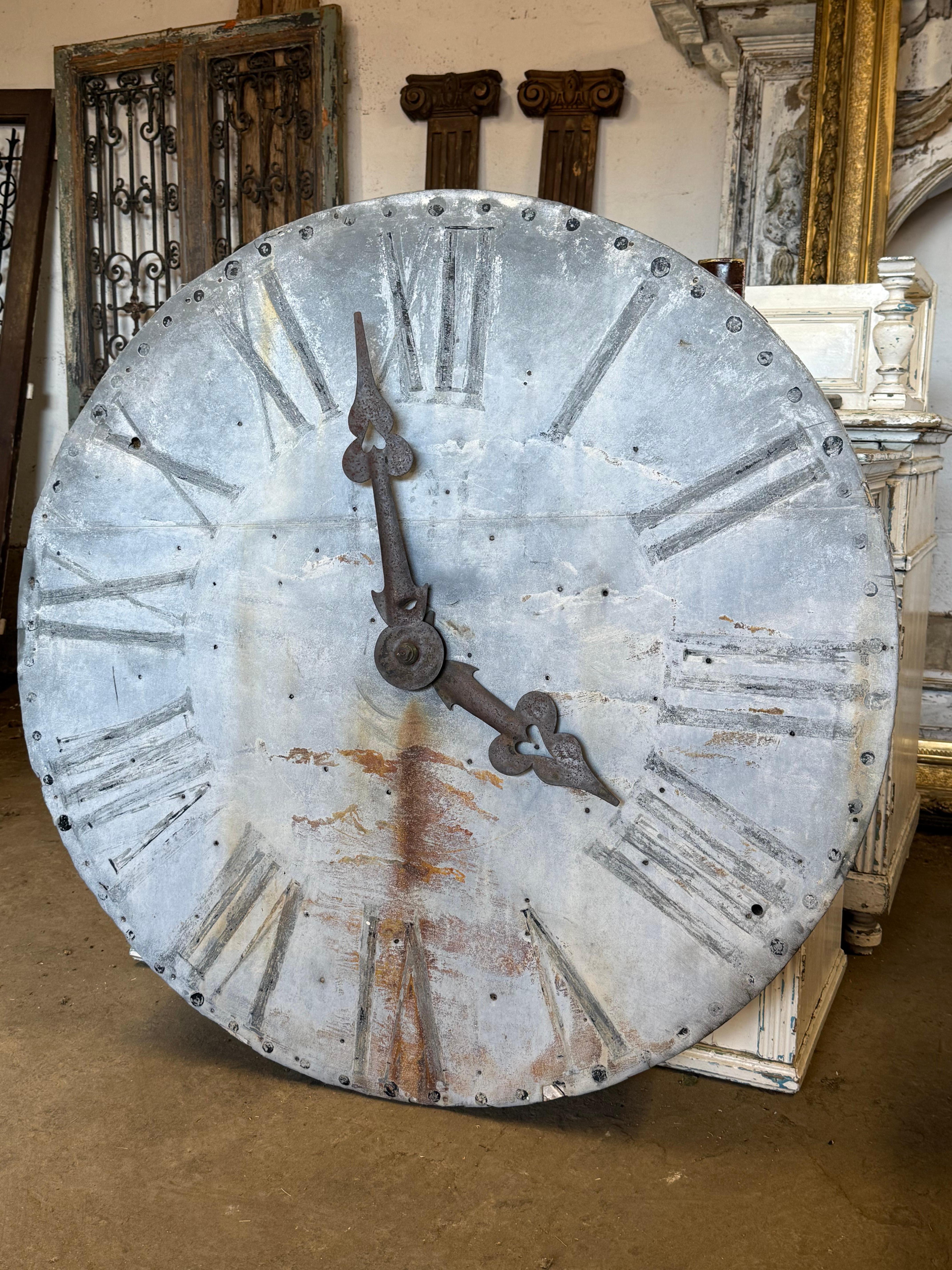 A nice late 19th century French tower clock face.

Made from zinc over a wooden frame. Original painted dial and metal hands. The hands move so can be adjusted. Remains of some of the original workings on the back. The face has 2 bullet holes which